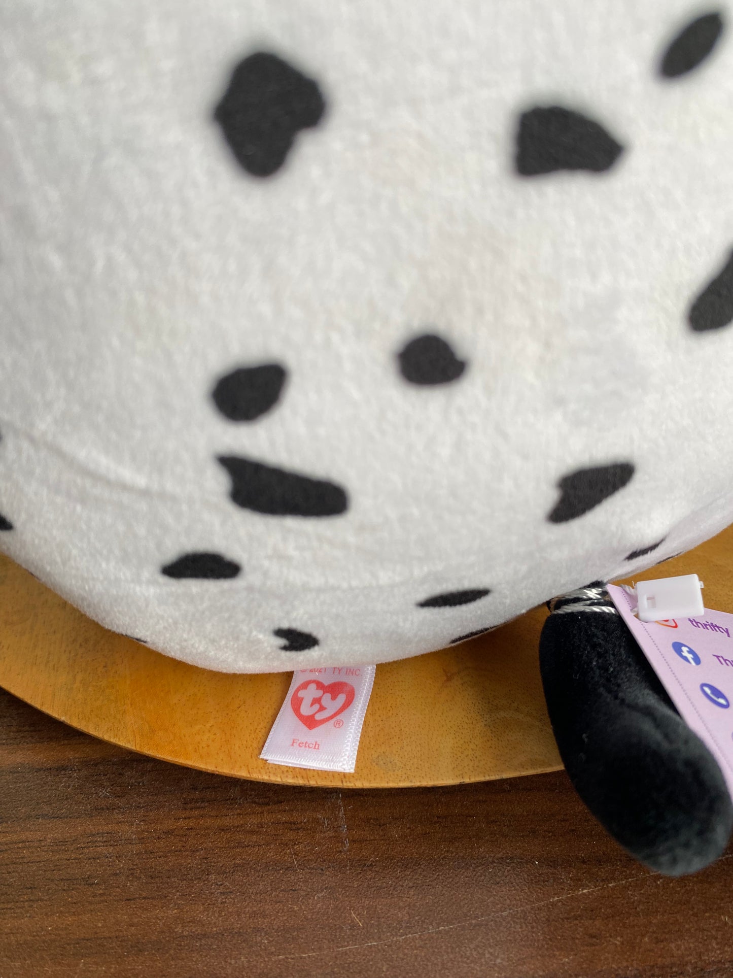 Dalmatian-themed plush toy from the Ty Squish. Fetch is a black and white Dalmatian dog with blue eyes and one black ear