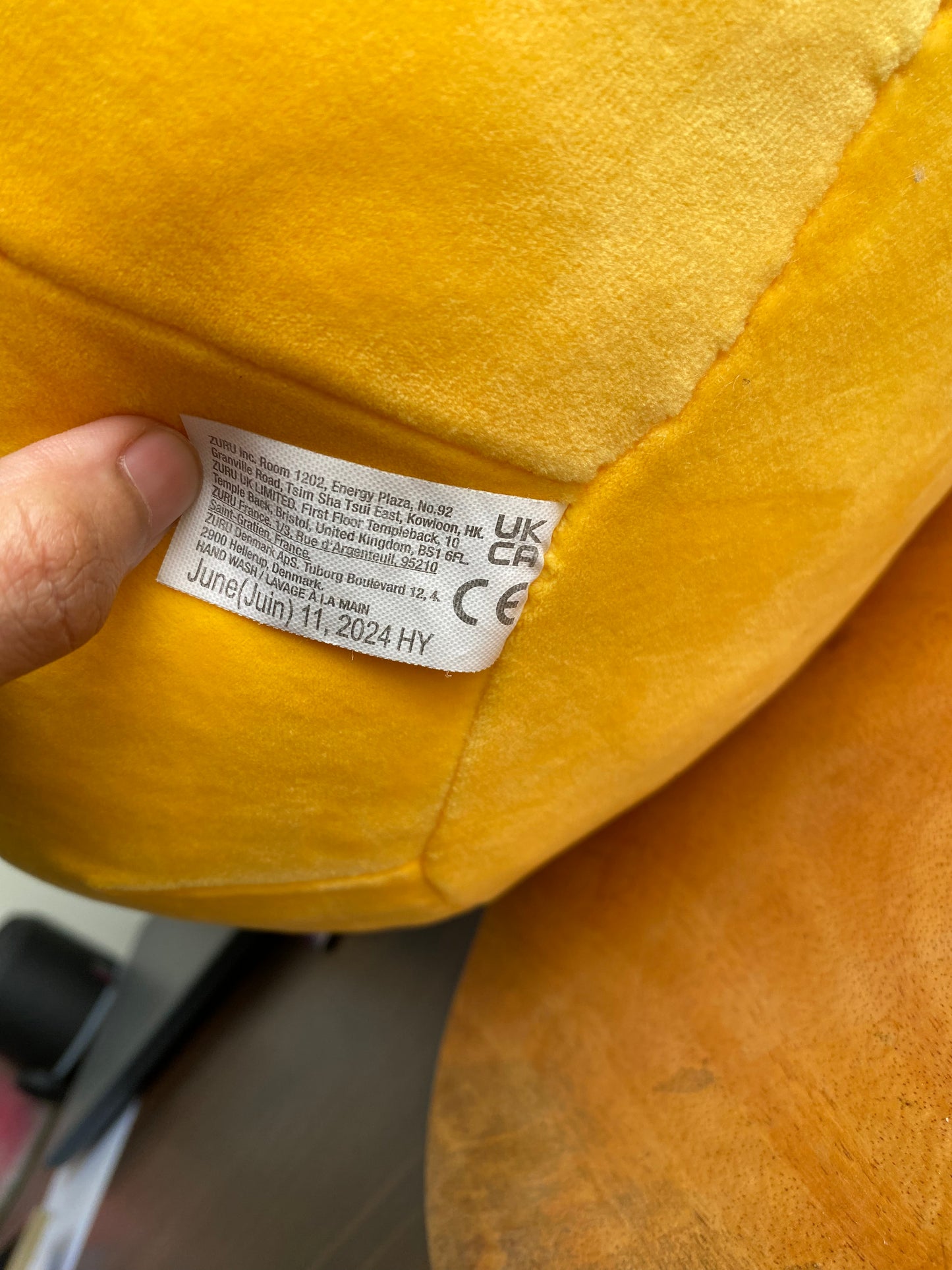 ZURU Snackles plush toy, specifically Sandy the Sloth holding a Dole Tropical Gold Pineapple