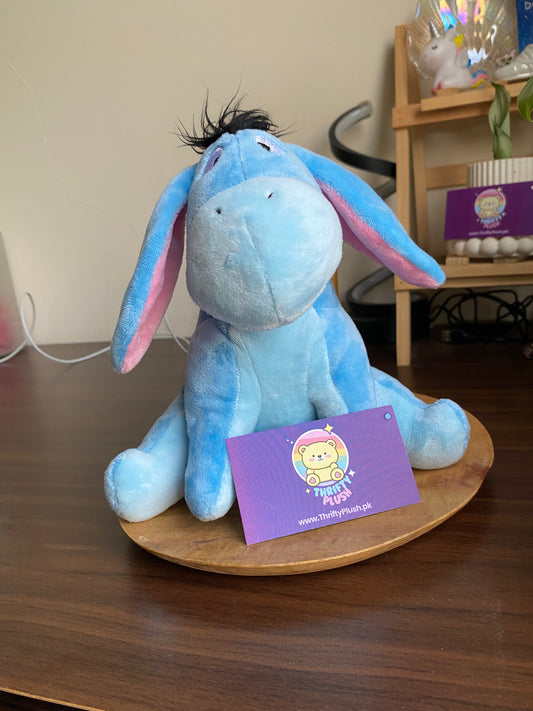 Blue Eeyore plush donkey toy with long floppy ears and fuzzy mane