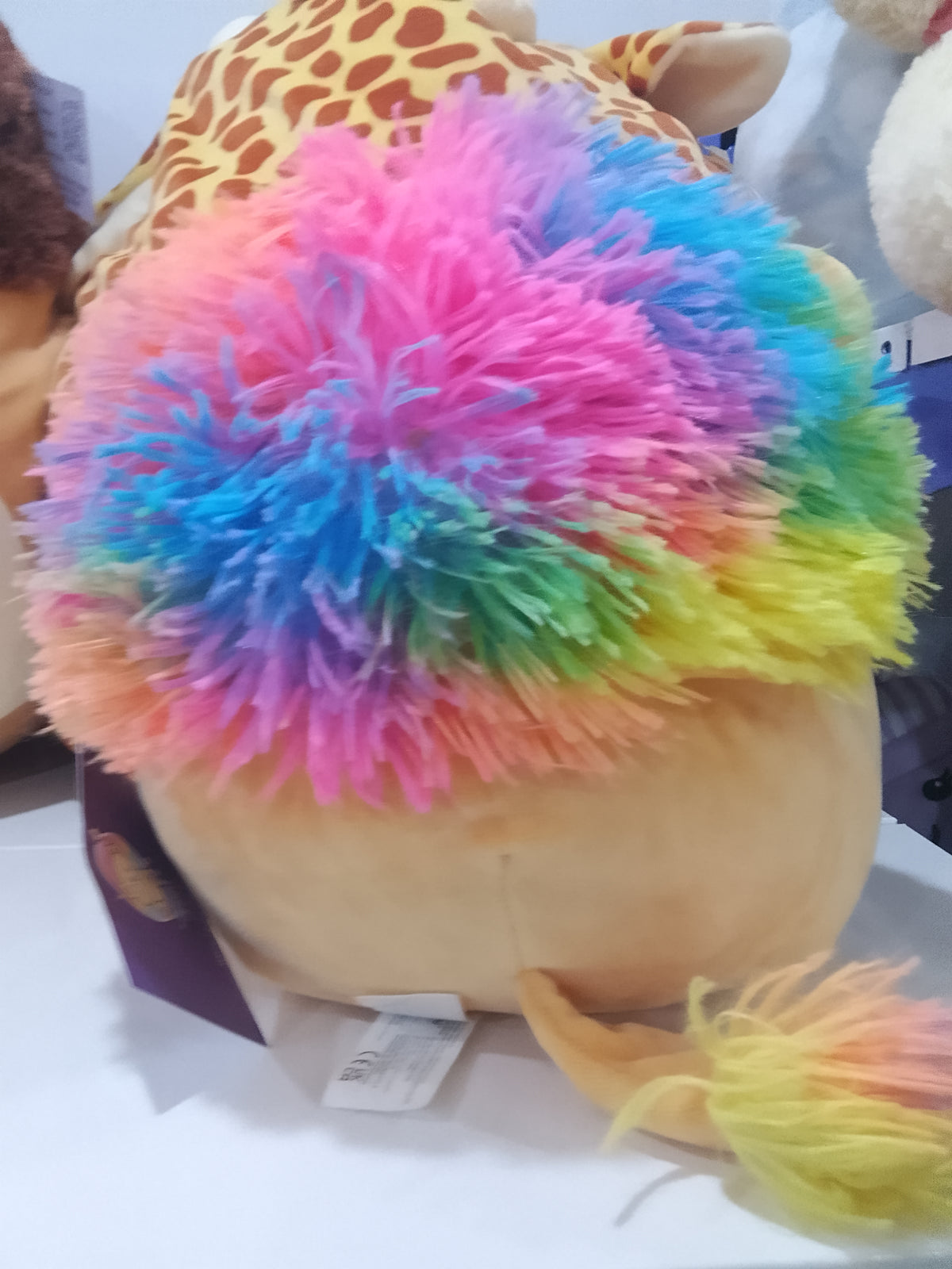 Squishmallows Lianne the Lion plush toy featuring a rainbow-colored mane.
