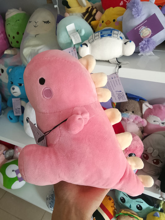 Yobush pink plush dinosaur toy holding a hear.