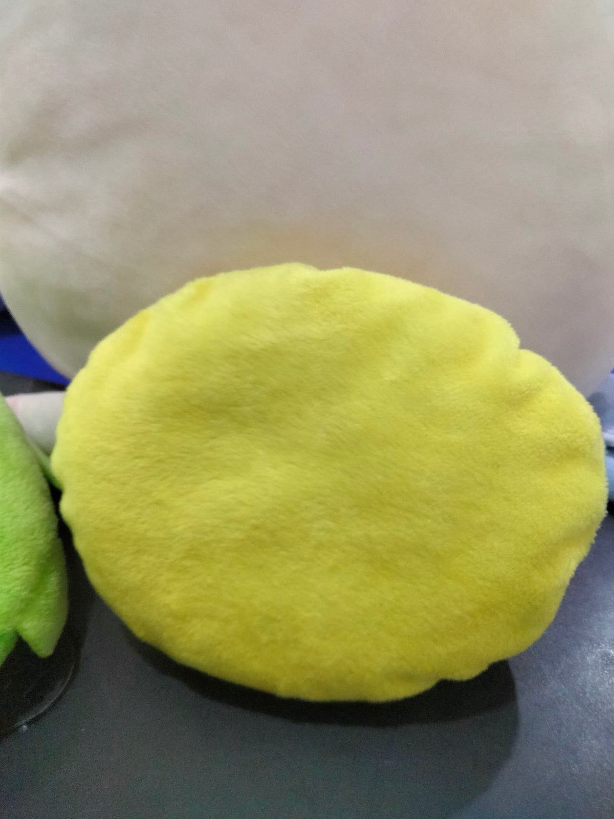 smiley emoji pillow with plush yellow fabric.