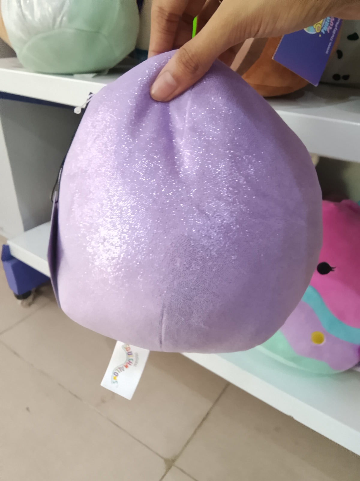 Squishmallows plush toy of Elle the Penguin in purple.