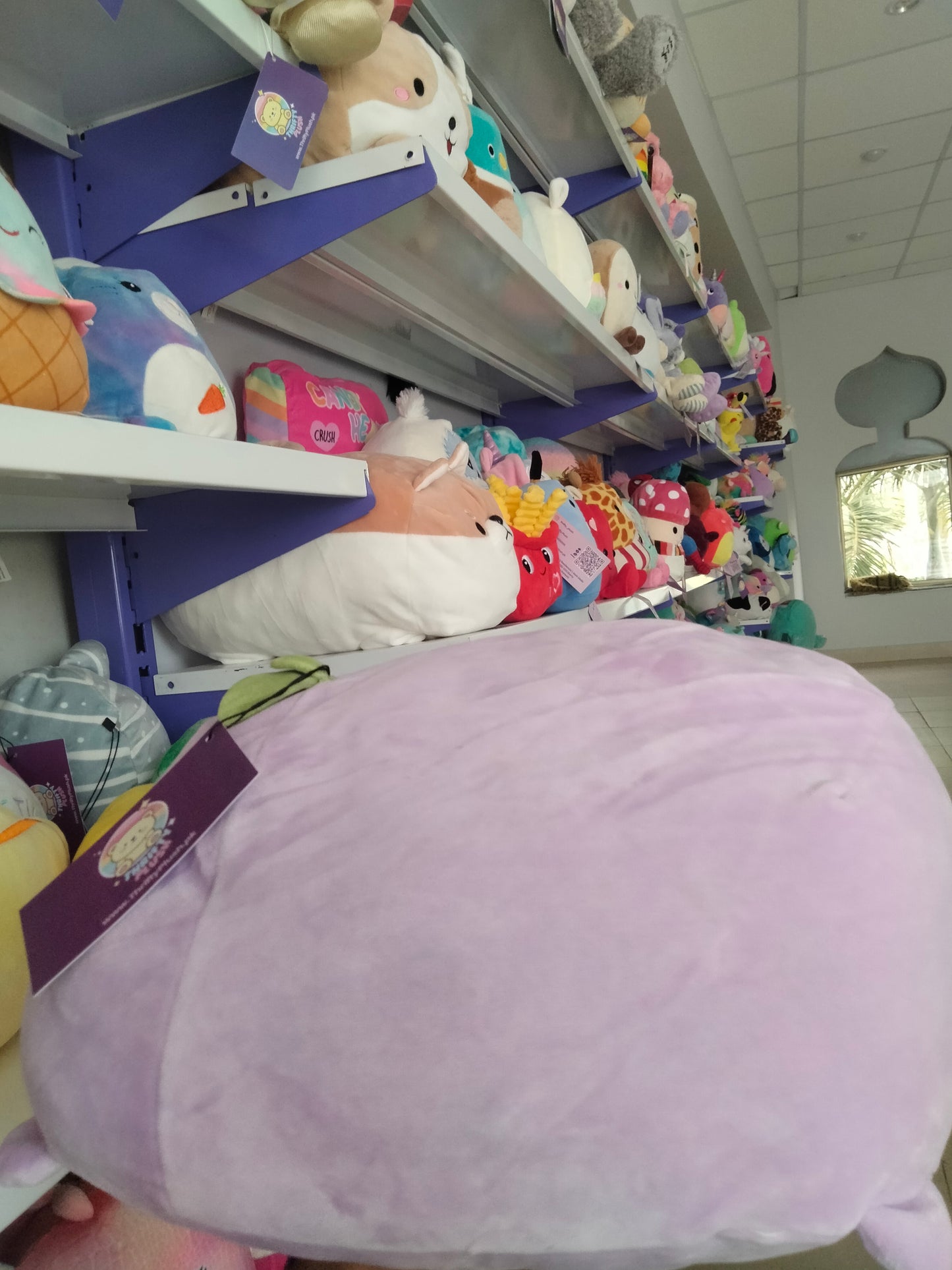 A soft, purple fruit-themed plush toy from Thrifty Plush.