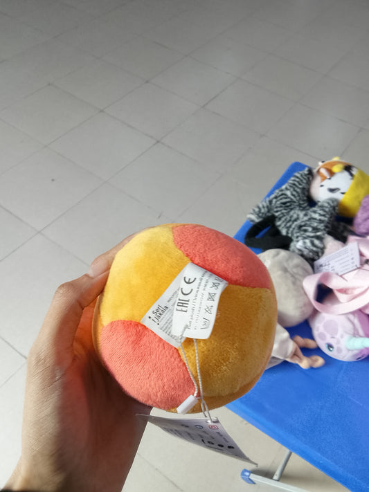 Ronaldinho branded orange plush soccer ball collectible.