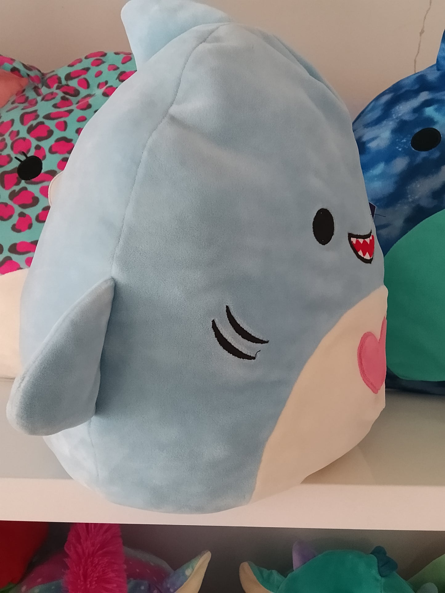 Squishmallows plush toy, specifically the character Rey the Blue Shark.