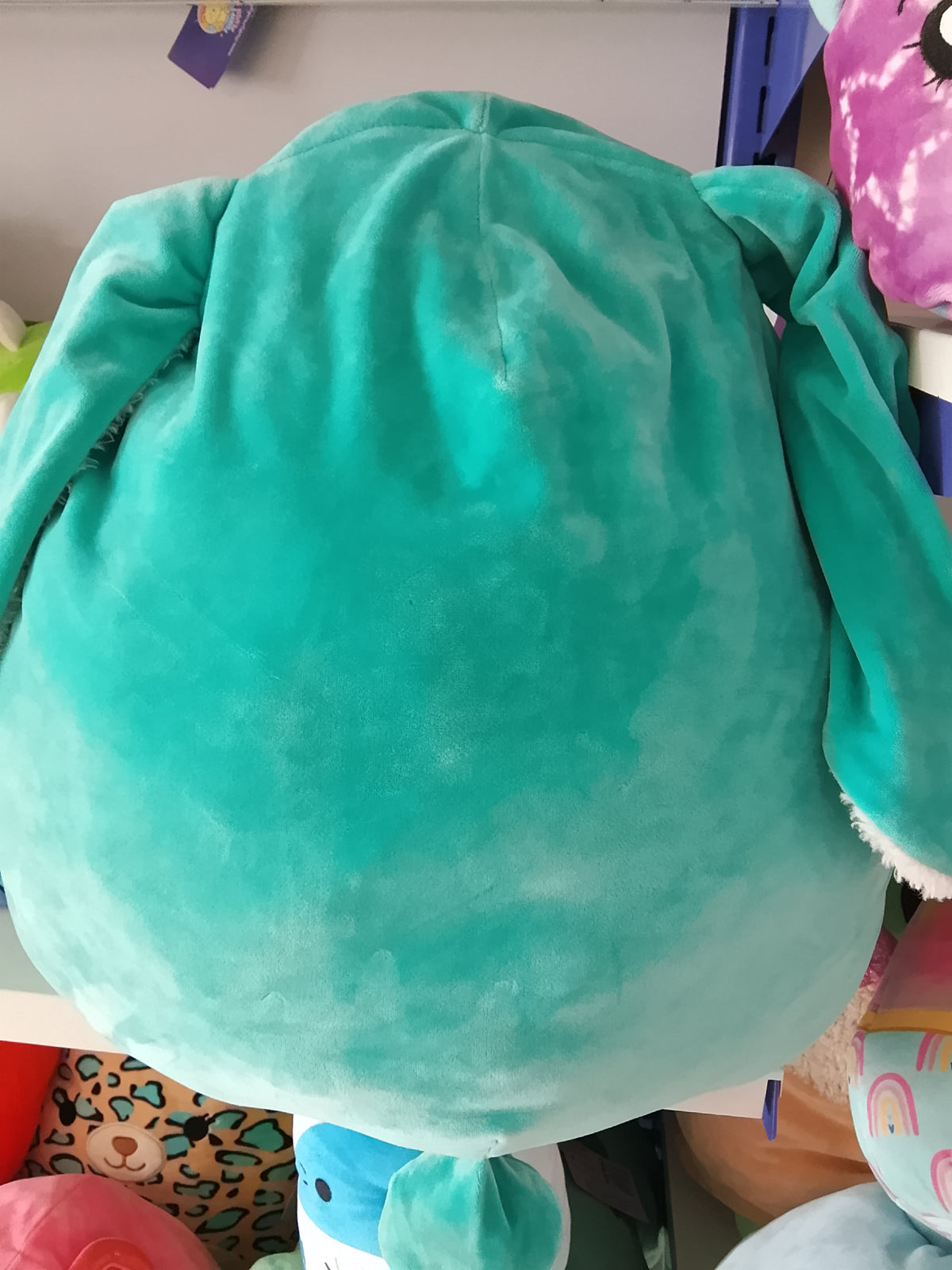 Squishmallows Official Regan the Teal Bunny plush toy.