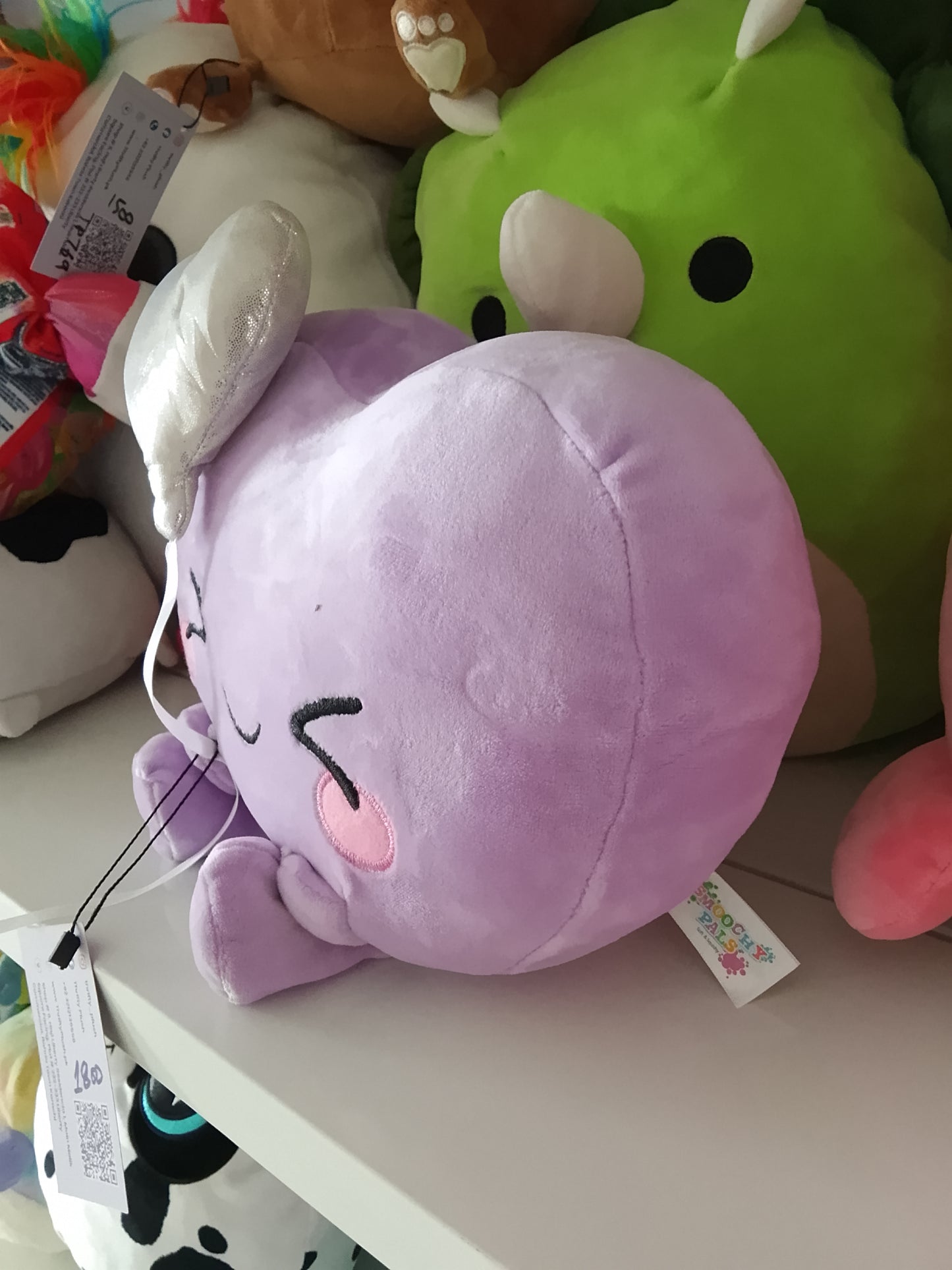 Purple heart holding a white balloon plush toy.