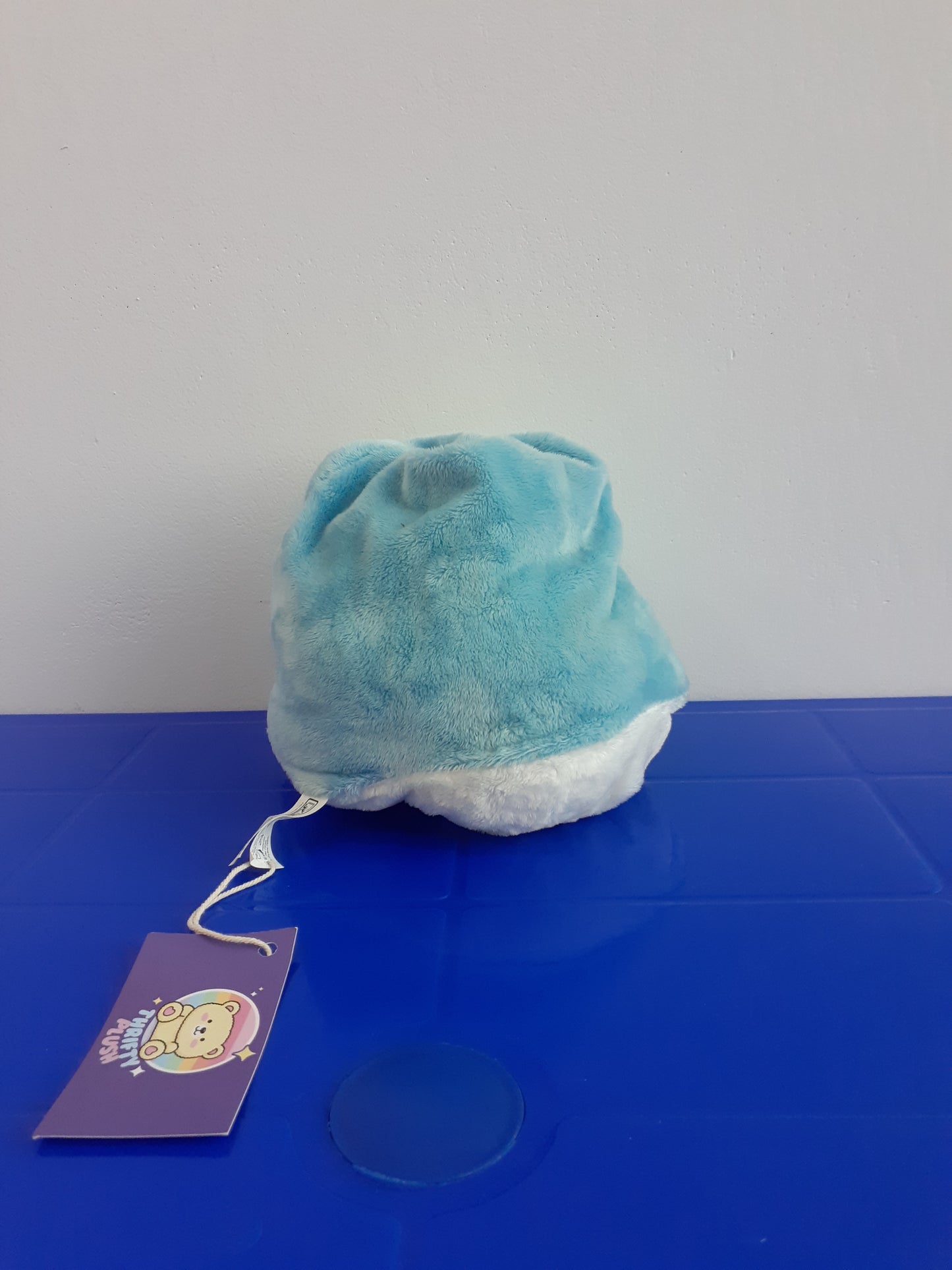 Pac-Man Reversible Ghost Plush Toy. It Is Light Blue And White
