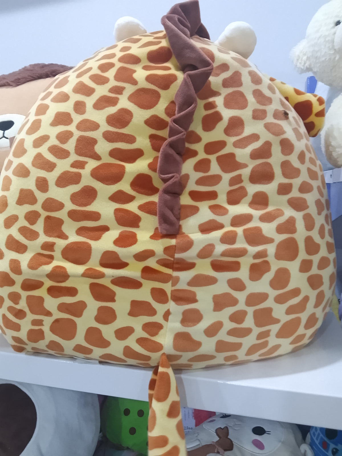 Squishmallows Gary the Giraffe plush toy featuring a unique silver sequin belly.
