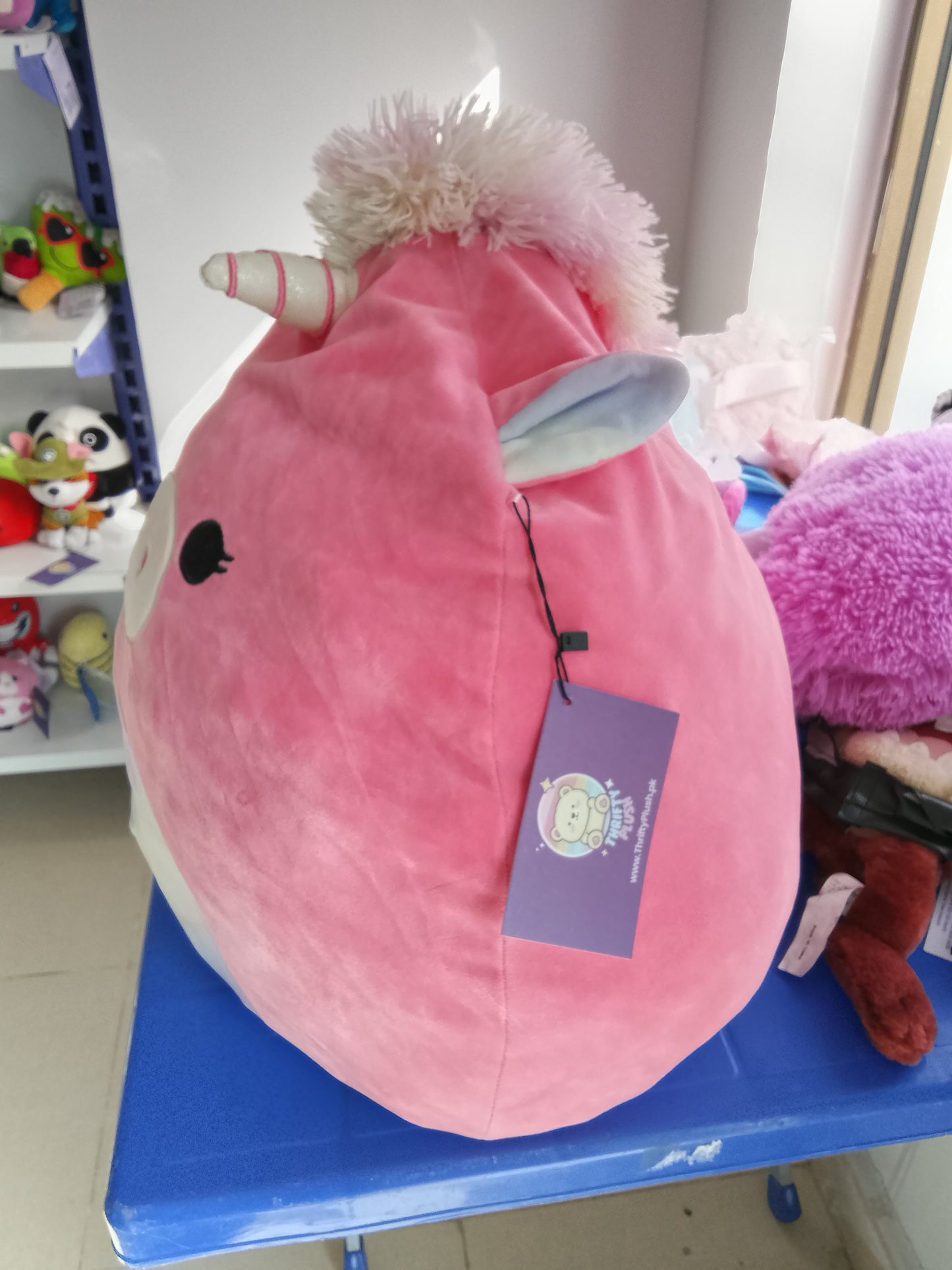 Kellytoy Squishmallows Sena the Pink Unicorn plush toy, soft pink exterior and a rainbow horn.