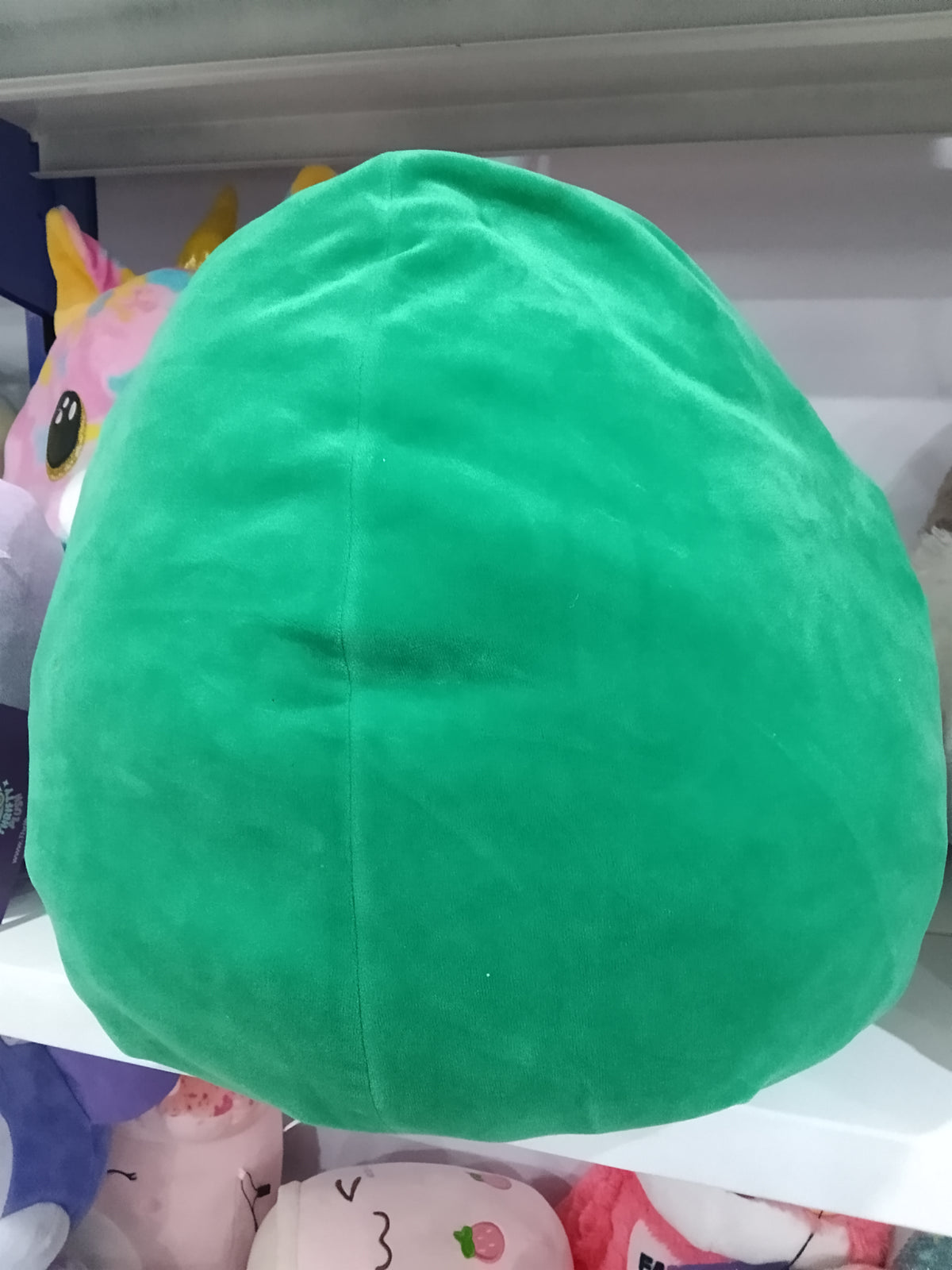 Squishmallows Austin the Avocado plush toy.