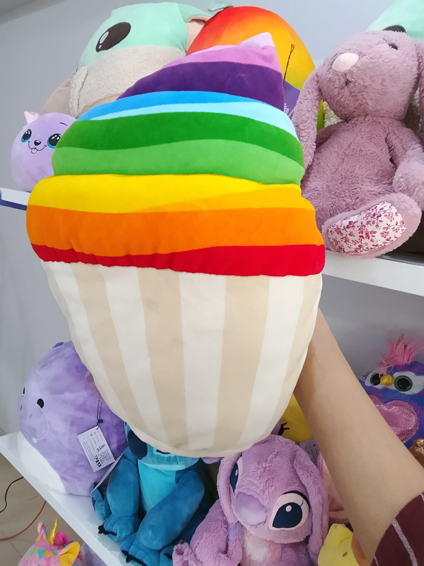 Squishmallows rainbow snow cupcake plush toy.