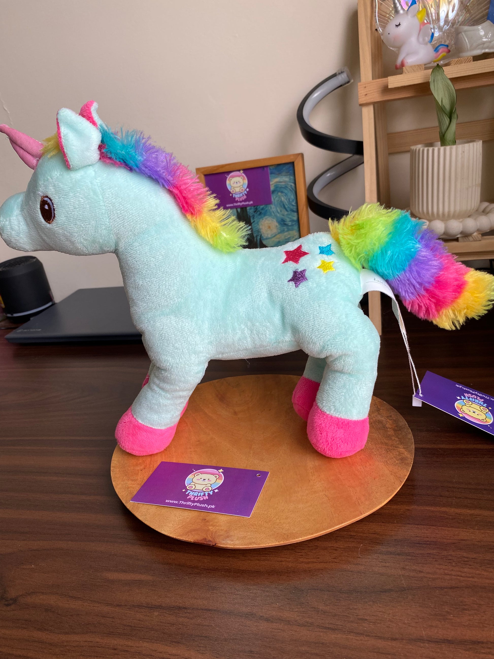 Rainbow unicorn plush stuffed animal toy with pastel mint body, rainbow mane and tail, pink hooves, and embroidered stars