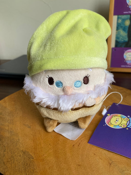 Yellow-hatted chibi-style Disney Ufufy Doc Dwarf plush with apple blossom scent tag