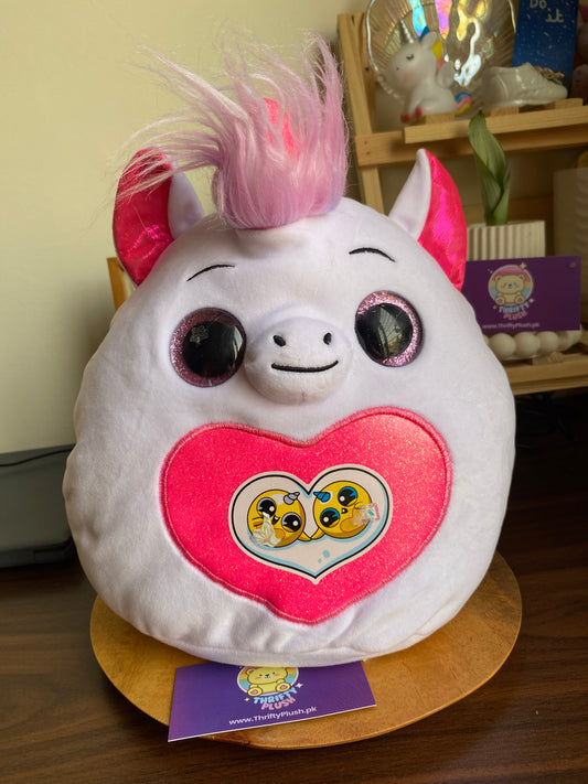 Photo of a Rainbocorns Fairycorn Surprise collectible plush unicorn emerging from a colorful surprise egg, accompanied by a pair of sparkly fairy wings, a tiara, and a magic wand.