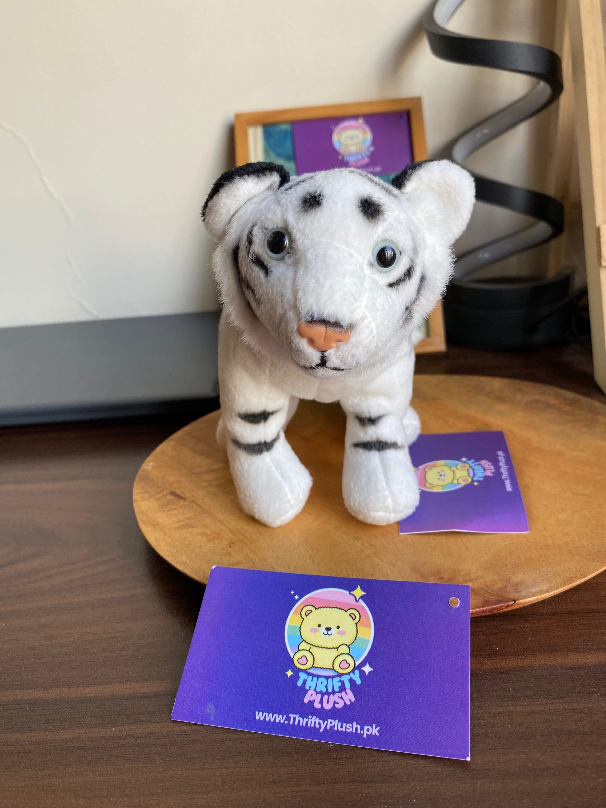 White tiger plush toy with black stripes, soft stuffed animal sitting pose