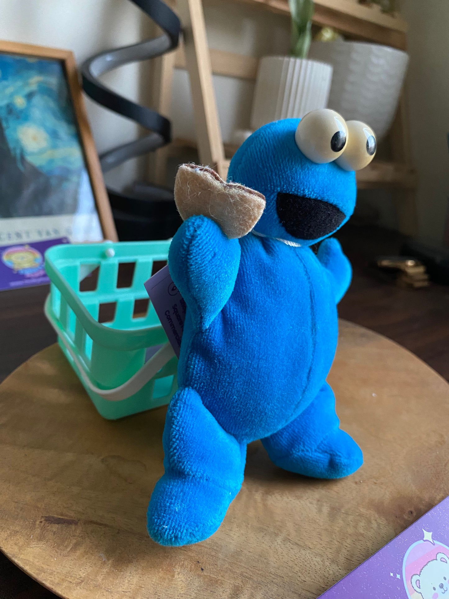 Cute Cookie Monster plush toy with googly eyes and big smile sitting on wooden surface — ThriftyPlush.pk