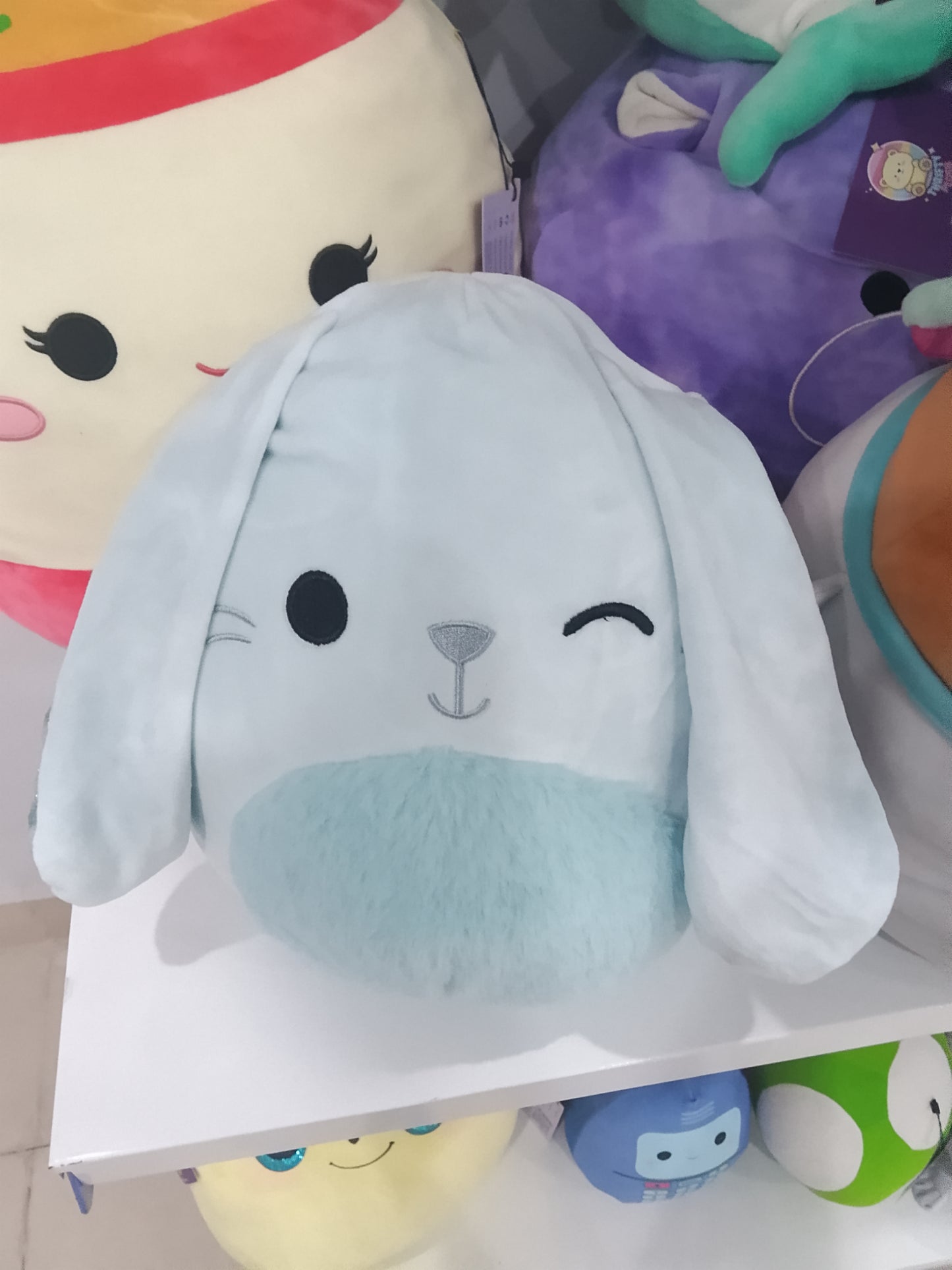 Squishmallows Bastian the Winking Blue Bunny plush toy.