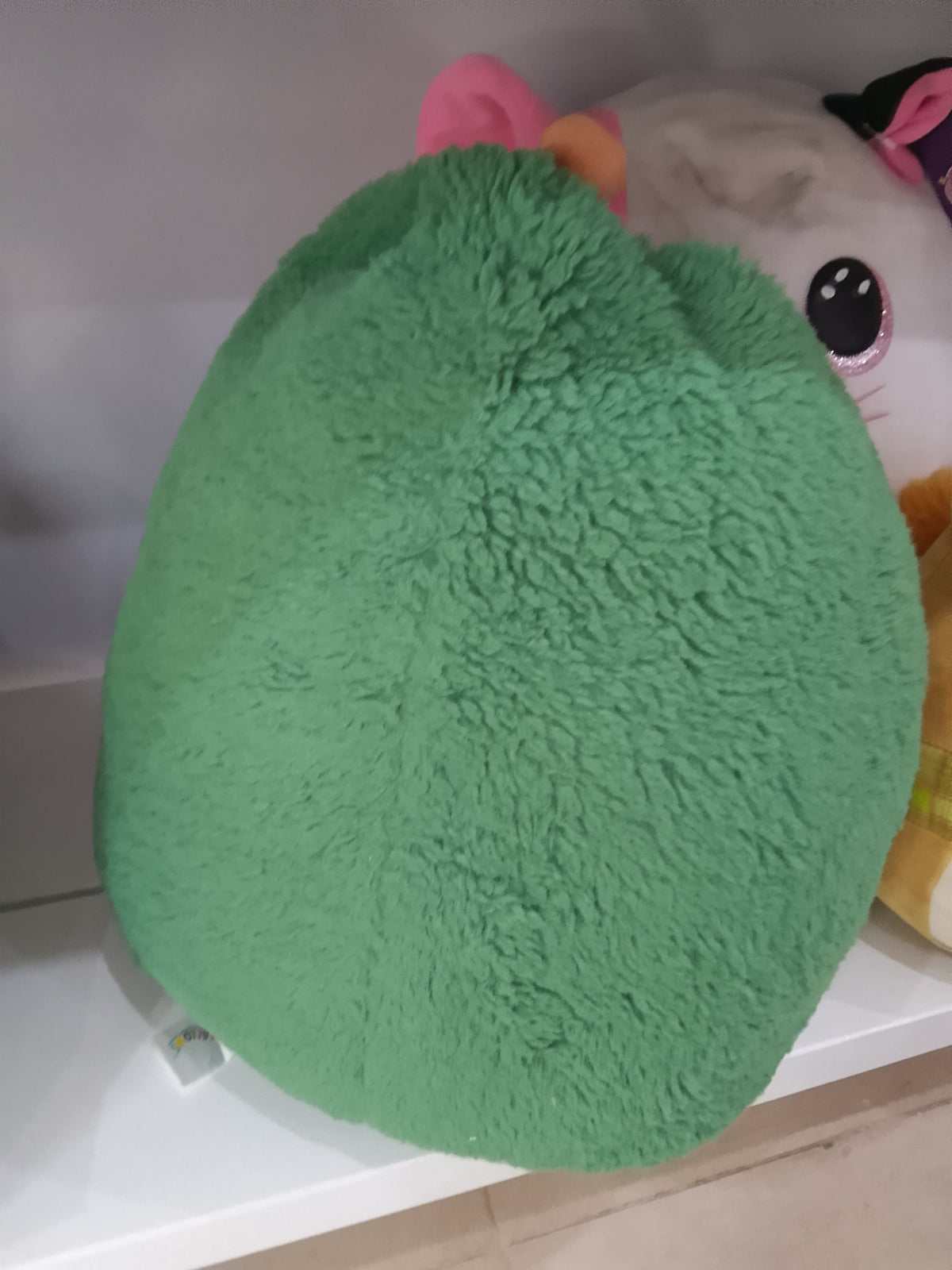 Squishmallows  Austin the Avocado plush toy from the FuzzAMallows collection.