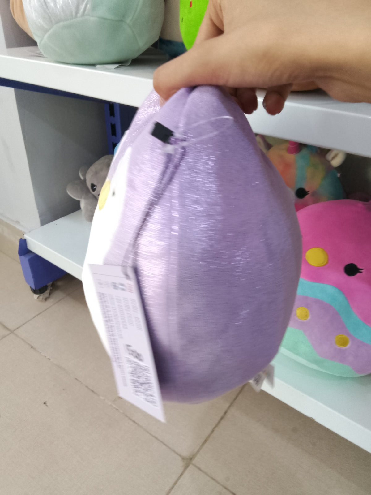 Squishmallows plush toy of Elle the Penguin in purple.