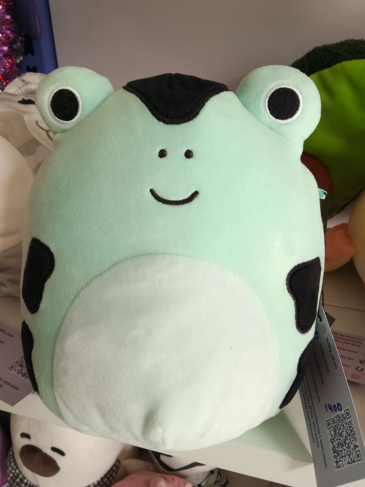 Squishmallows Dear the Poison Dart Frog plush toy speckled mint green and black design.