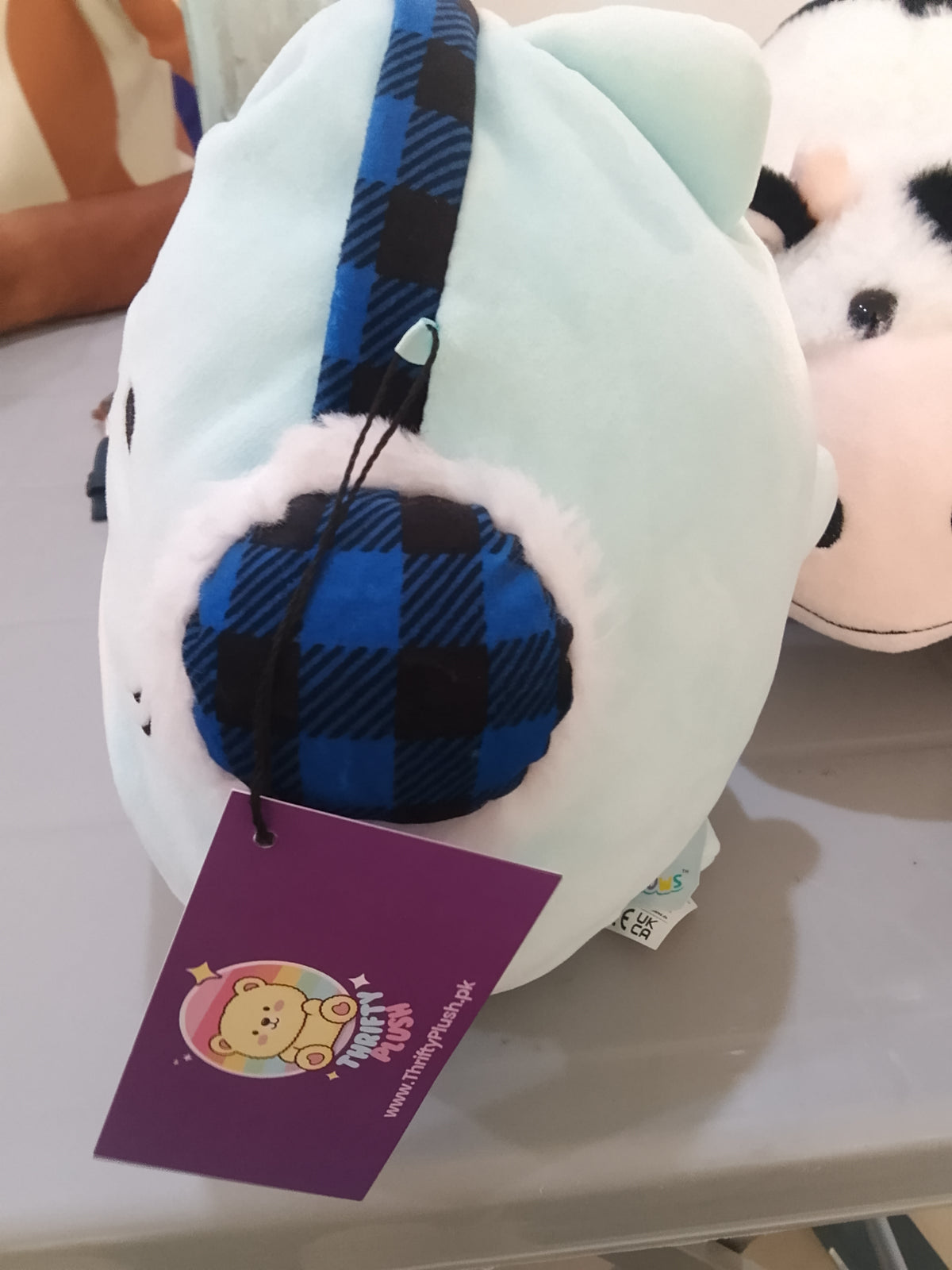 Squishmallows Sharon the Shark Holiday plush featuring festive earmuffs