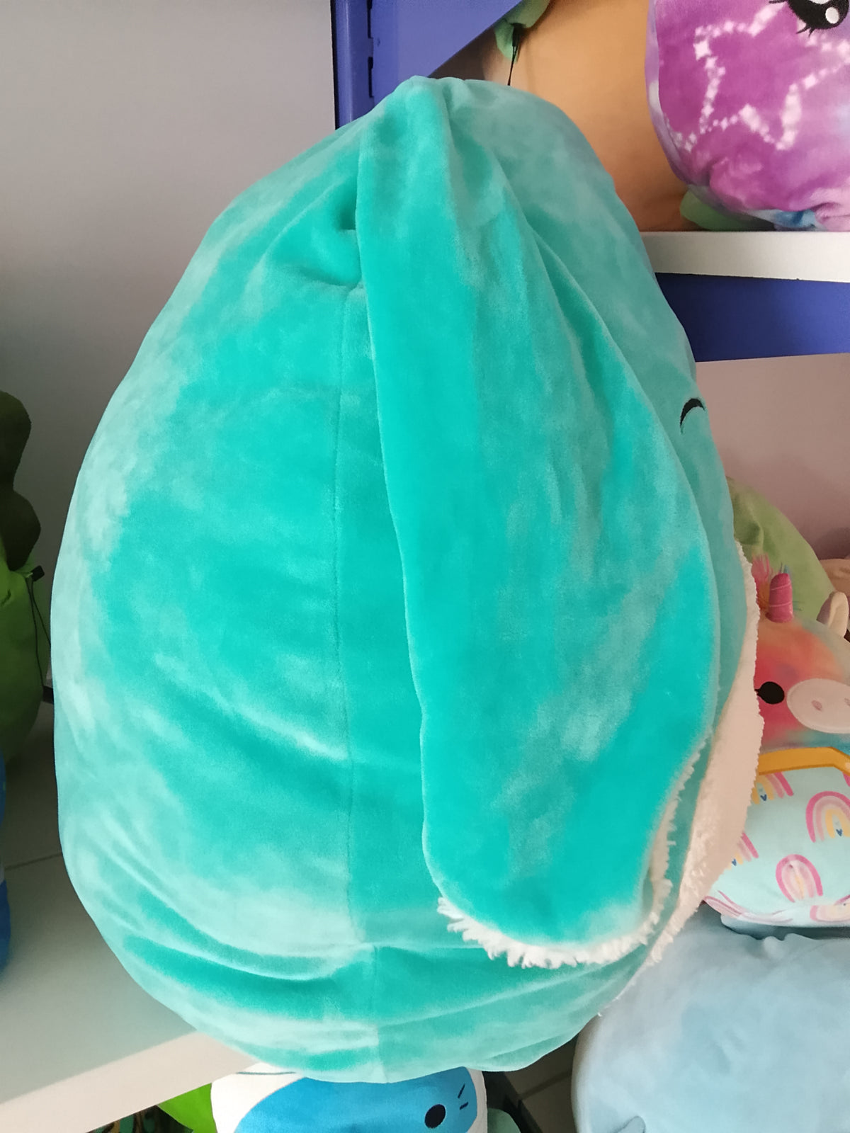 Squishmallows Official Regan the Teal Bunny plush toy.