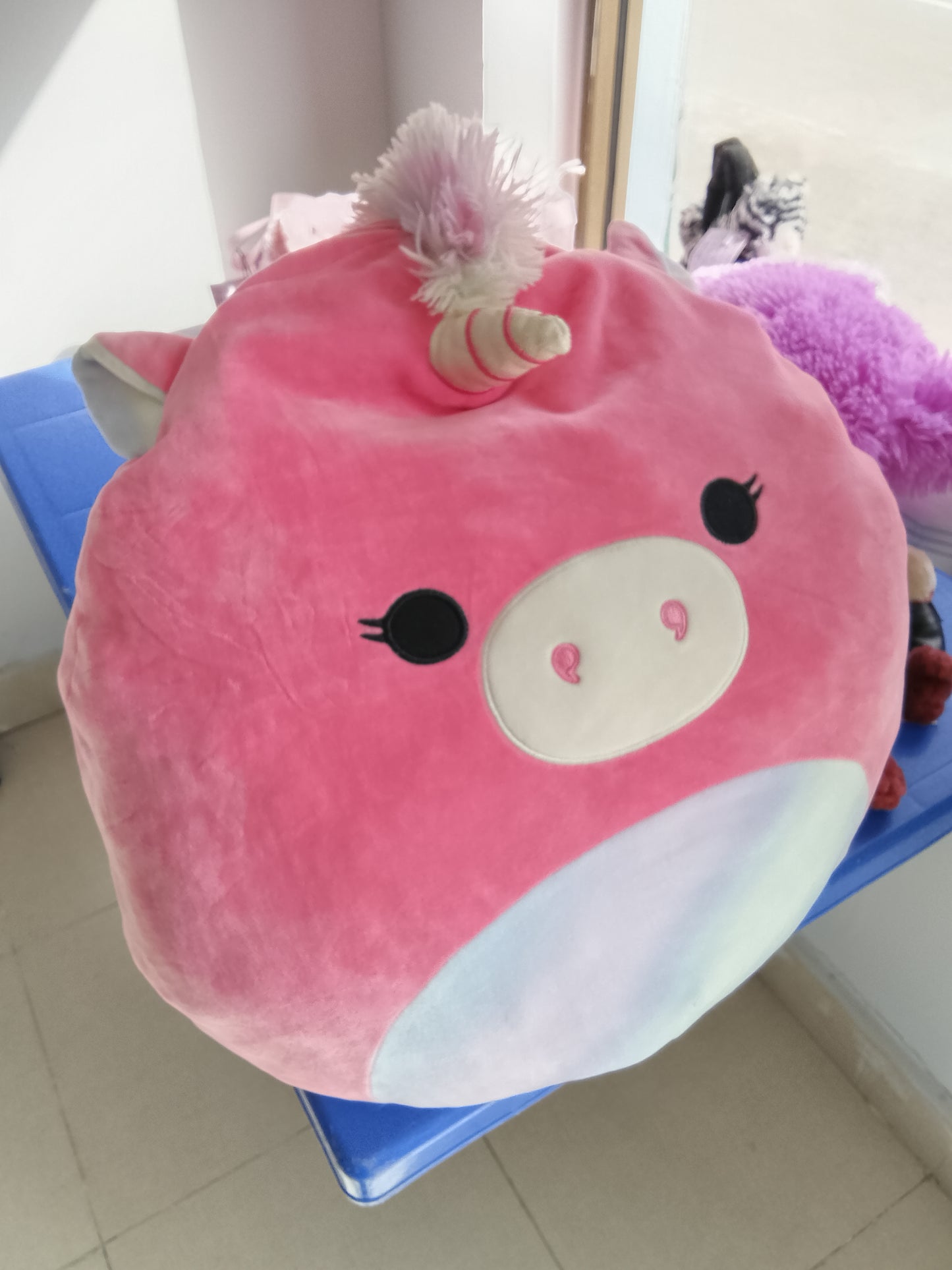Kellytoy Squishmallows Sena the Pink Unicorn plush toy, soft pink exterior and a rainbow horn.