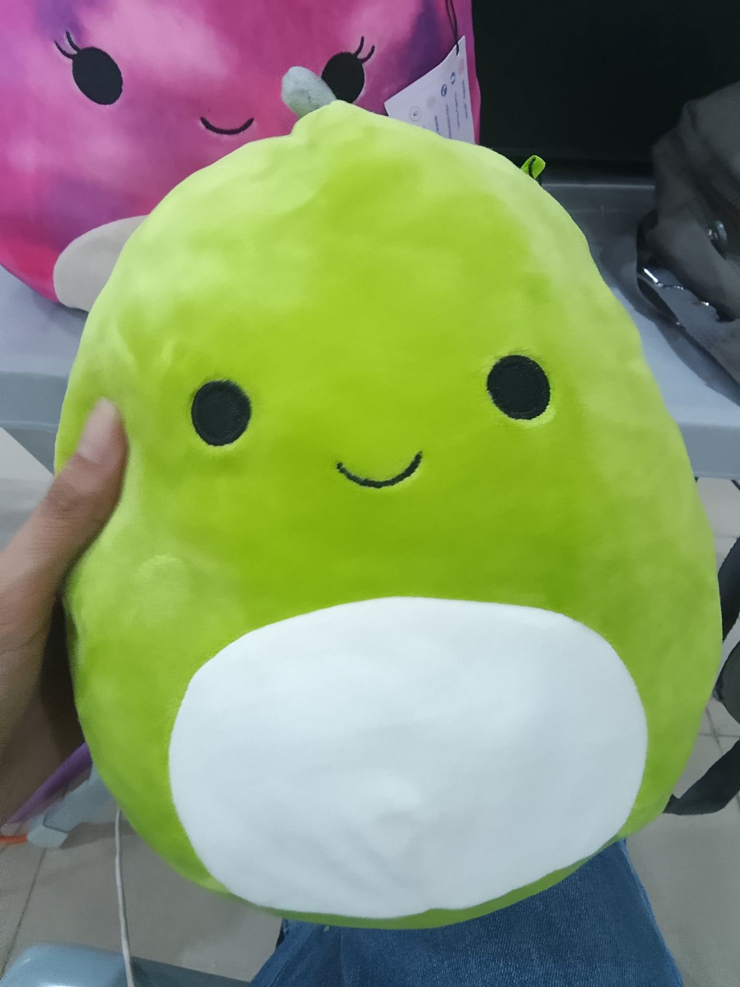 Squishmallows plush toy featuring Arlie the green dinosaur.
