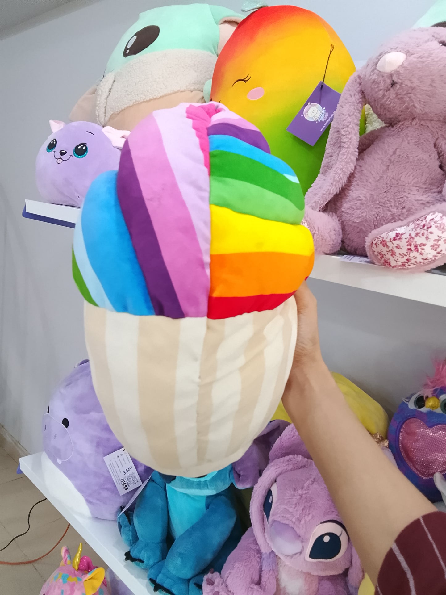 Squishmallows rainbow snow cupcake plush toy.
