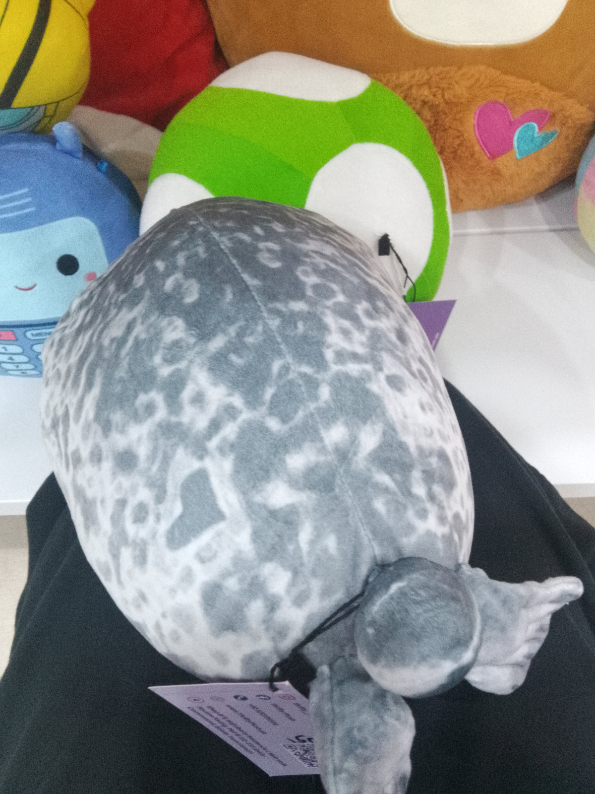 Squishmallow-style chubby ringed seal plush toy mottled grey and white pattern
