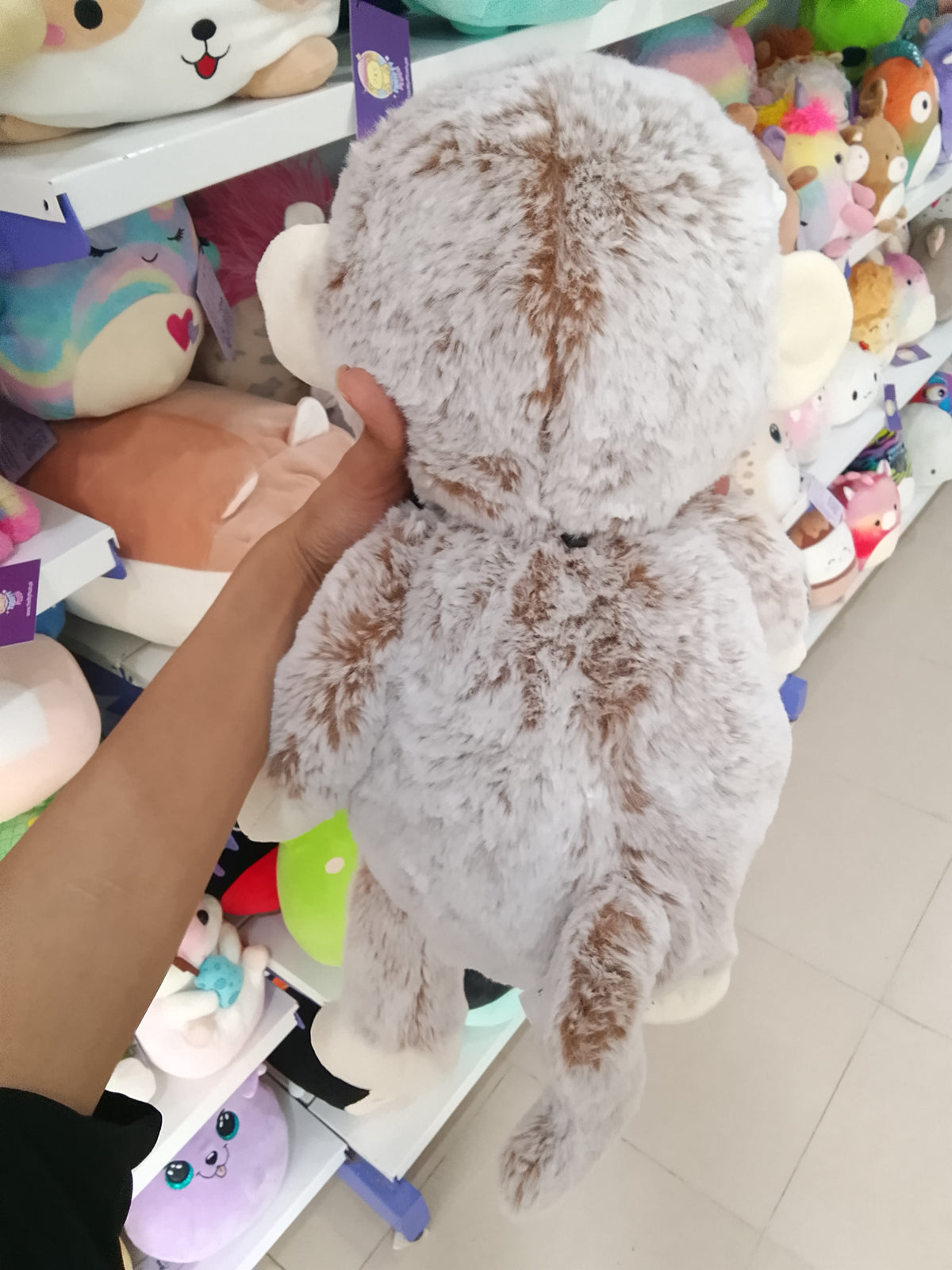 Kid Connection gray and white monkey plush toy.