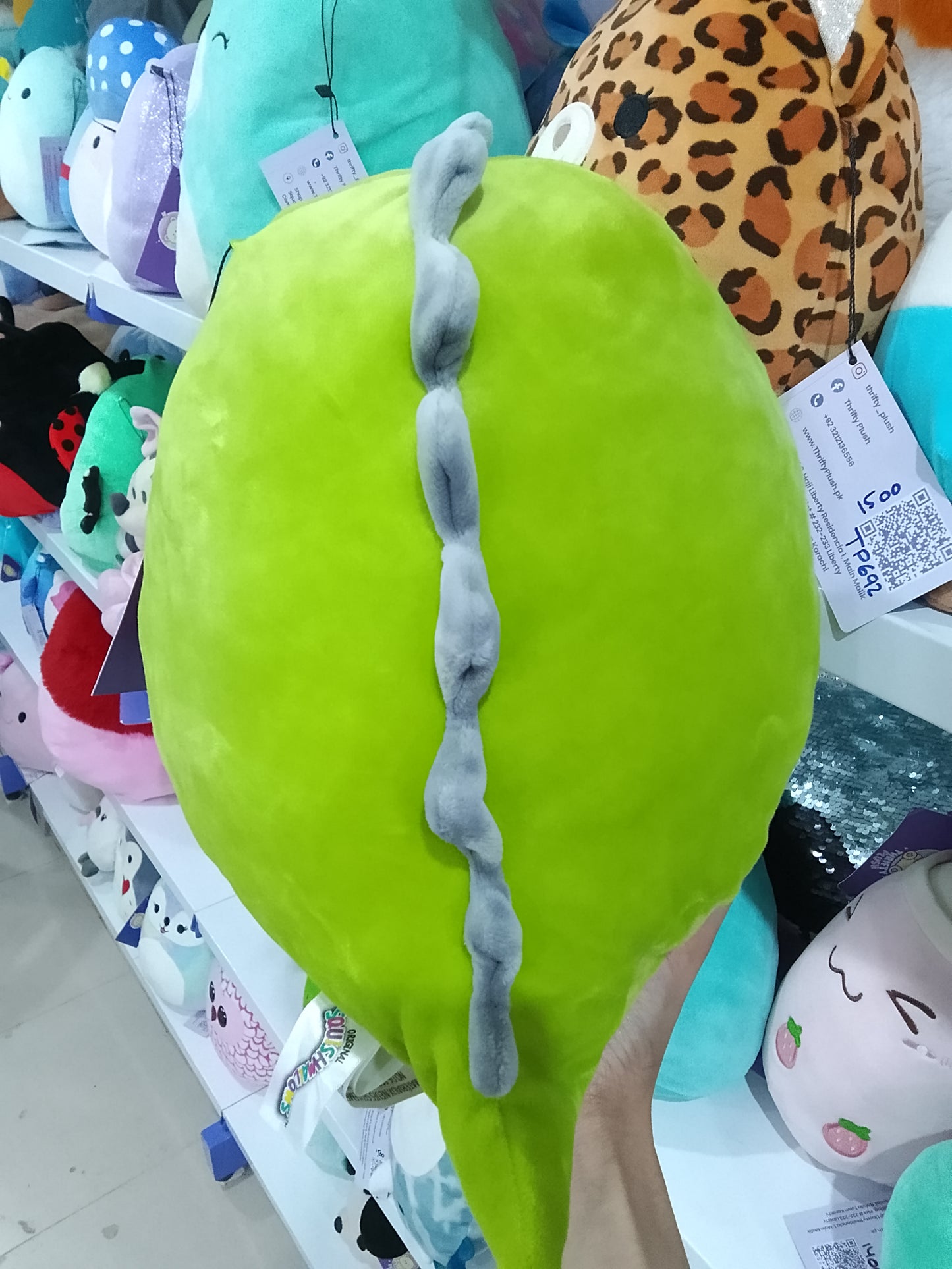 Squishmallows green dinosaur character, likely Danny or Arlie plush toy.