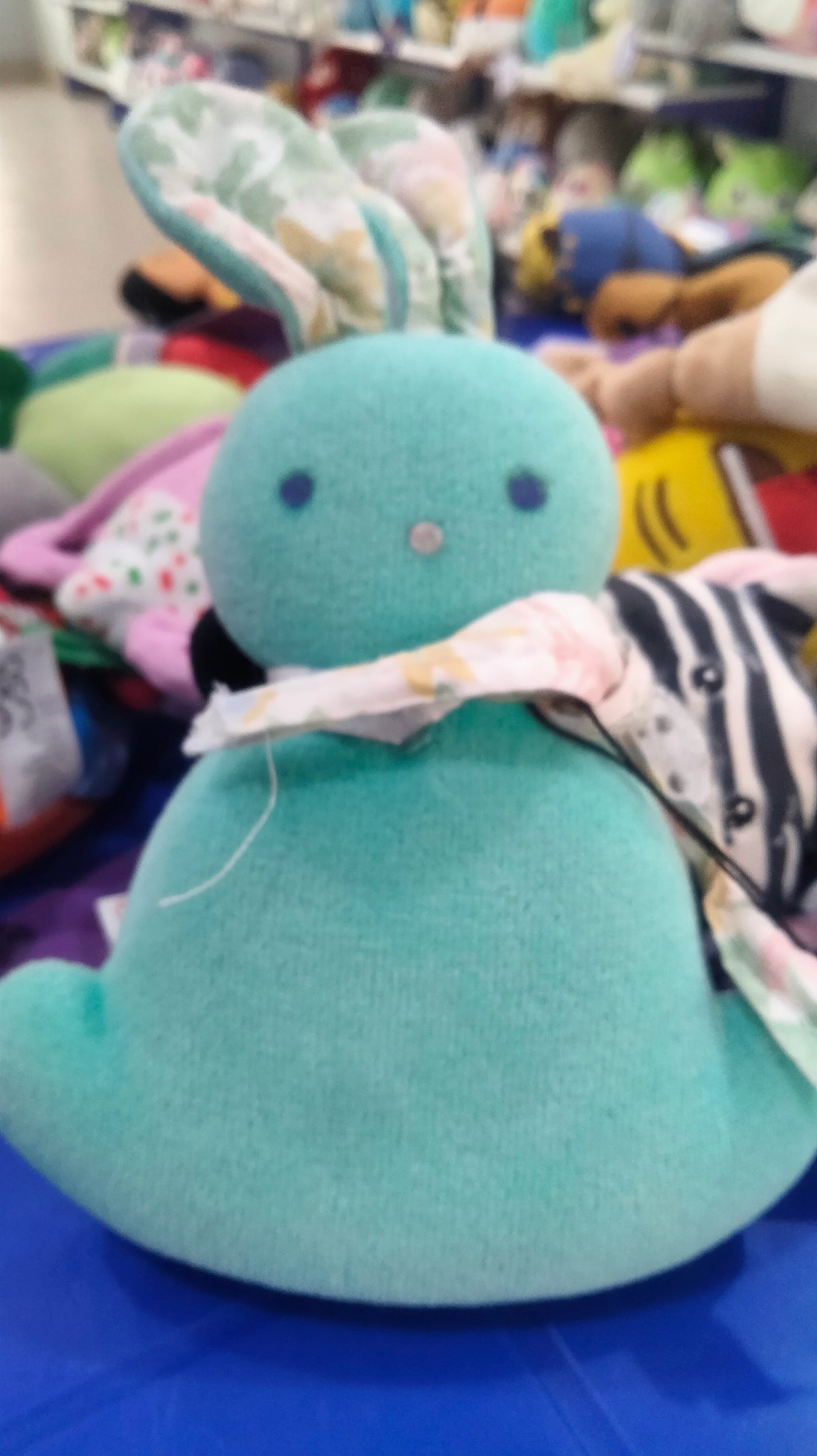 This plush toy is a turquoise IKEA GREJSIMOJS soft toy.
