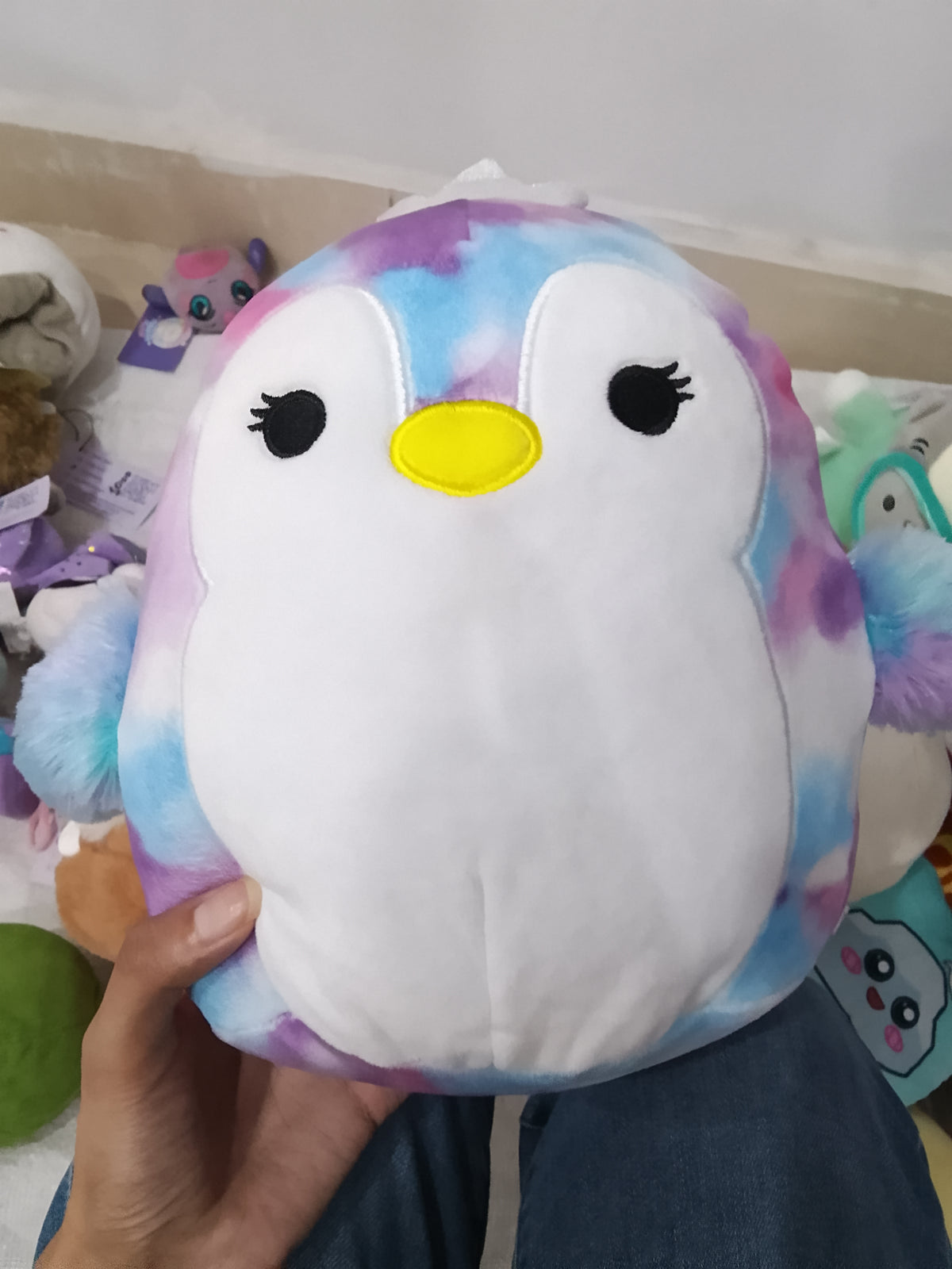 Squishmallows Tomara the Penguin tie-dye plush toy.