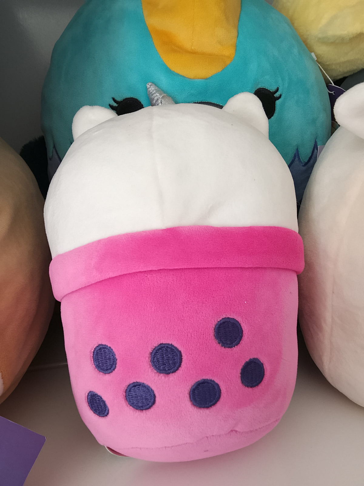 bubble tea cup featuring a unicorn character plush toy.