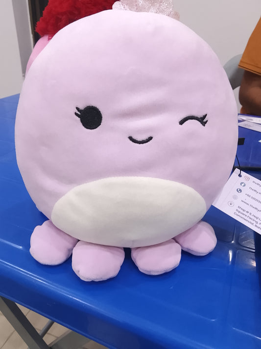 Squishmallows Violet the Octopus plush, recognizable by its light purple color, winking expression, and silver crown.