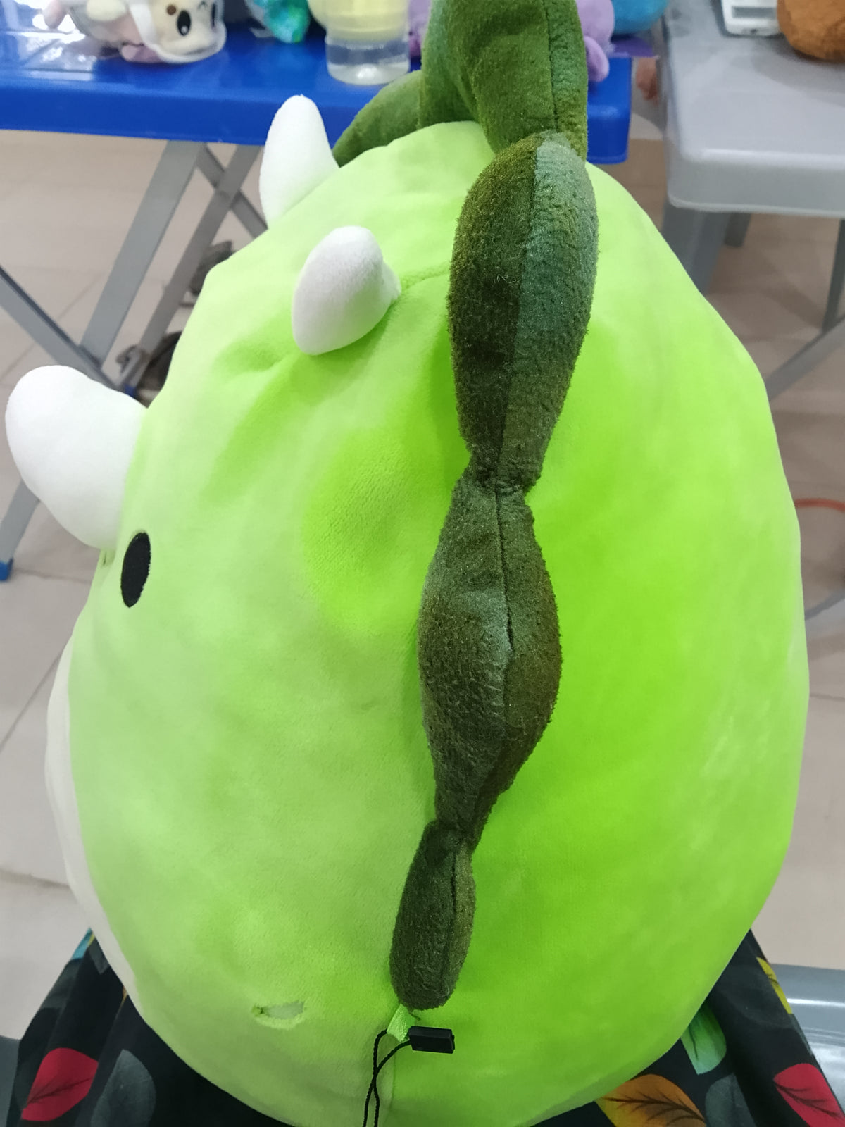 Squishmallows plush toy featuring Tristan the Green Triceratops dinosaur.