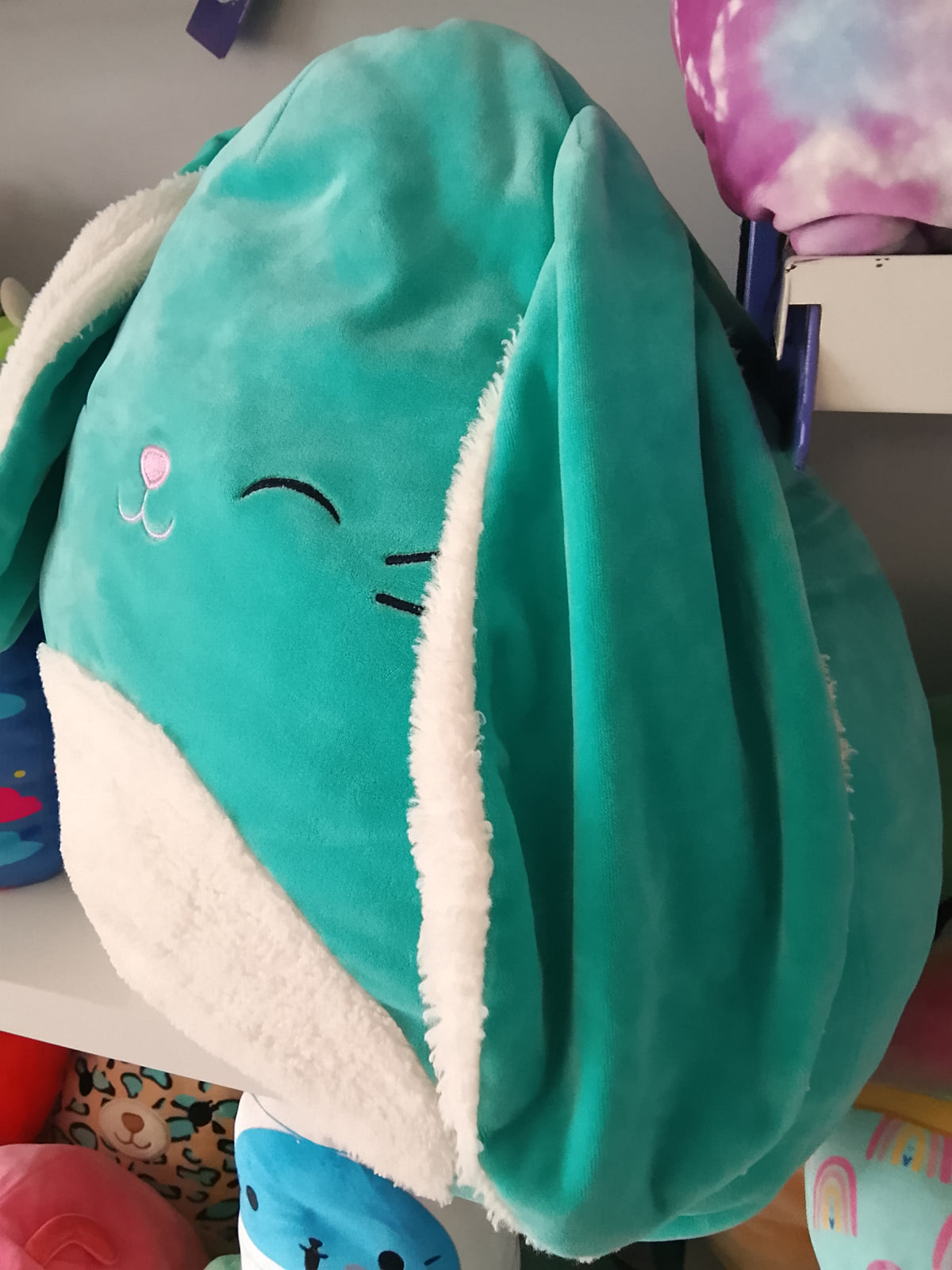 Squishmallows Official Regan the Teal Bunny plush toy.