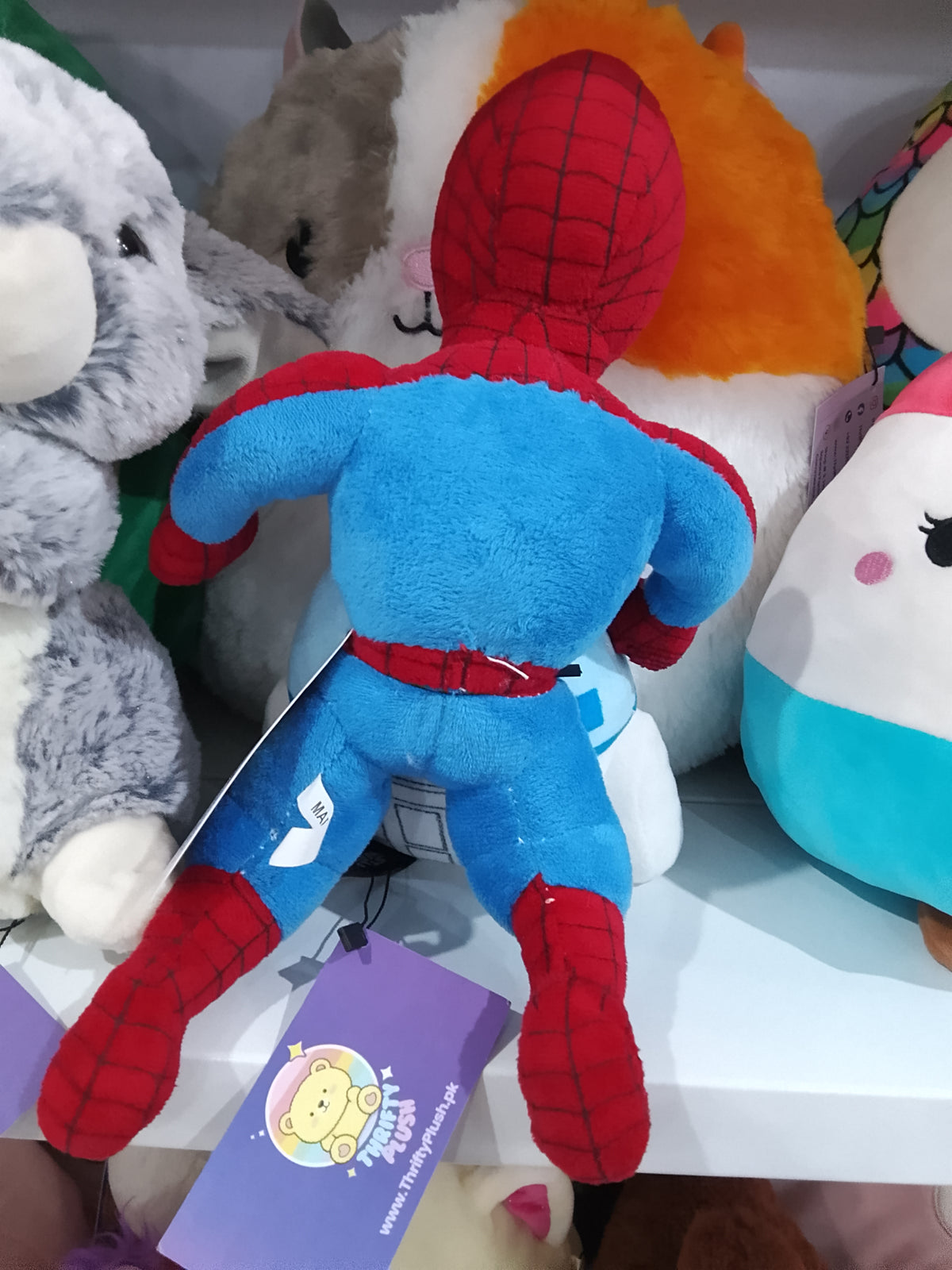 Spider-Man "JAMAICA YEAH MON" patch on its chest plush toy.