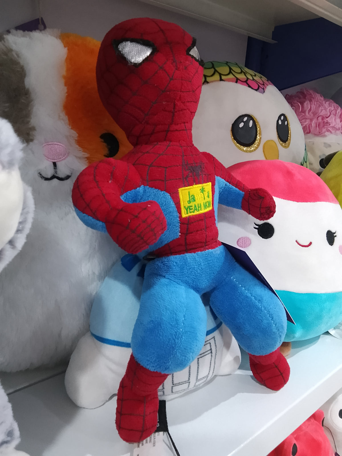 Spider-Man "JAMAICA YEAH MON" patch on its chest plush toy.