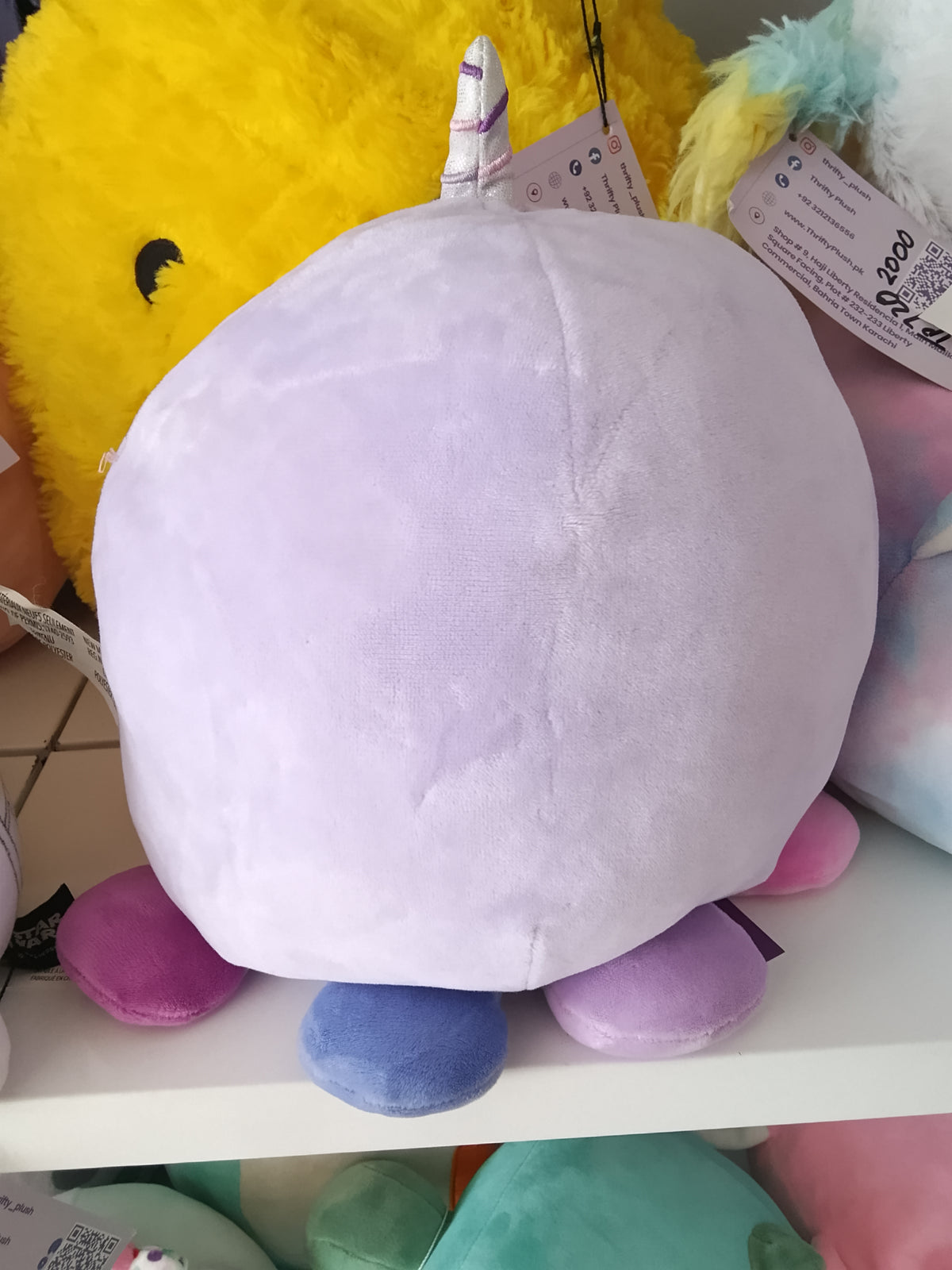 Squishmallows Naomi the Lavender Narwhal plush toy.