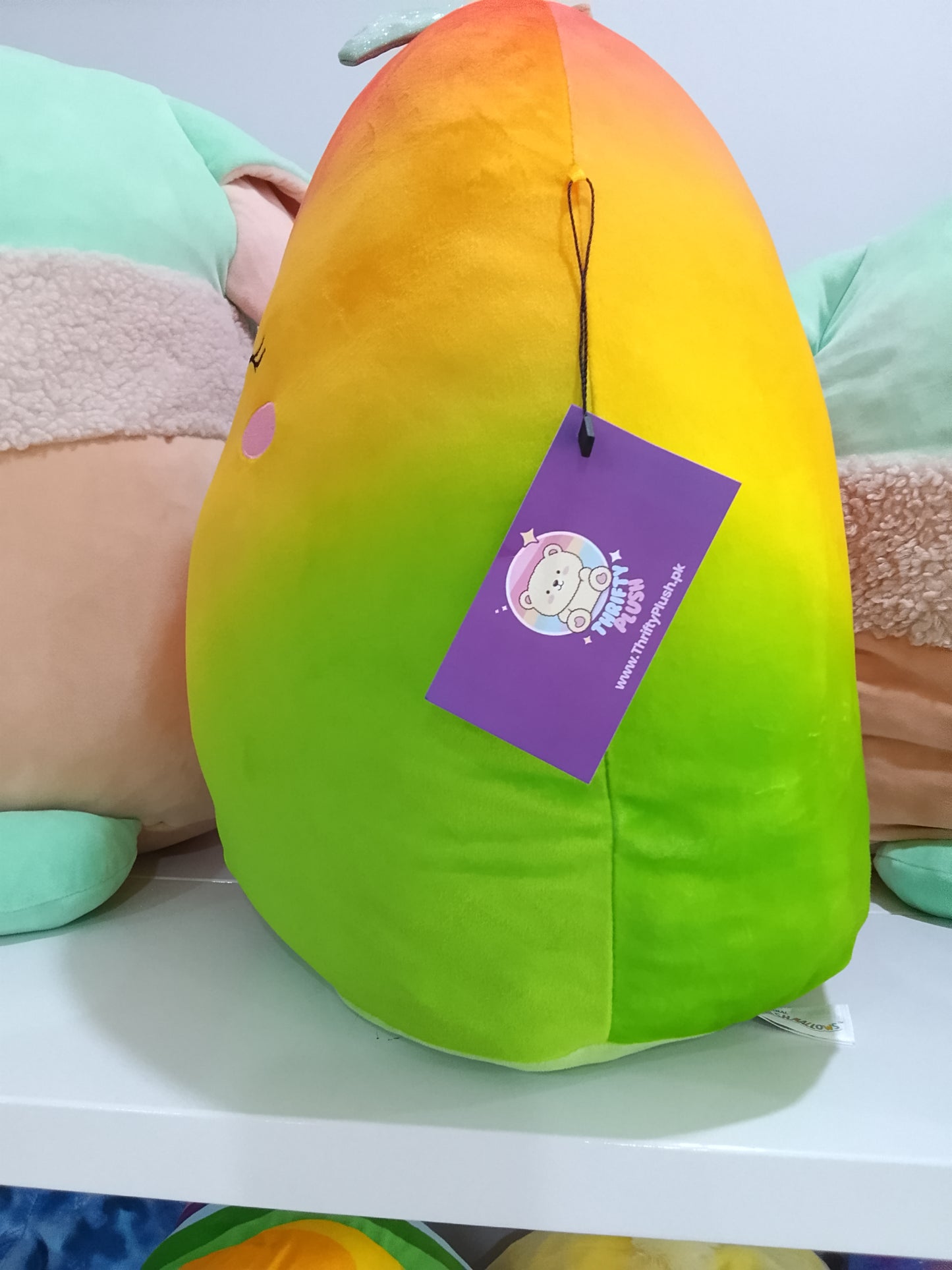 Squishmallows Ximena the Mango plush toy.