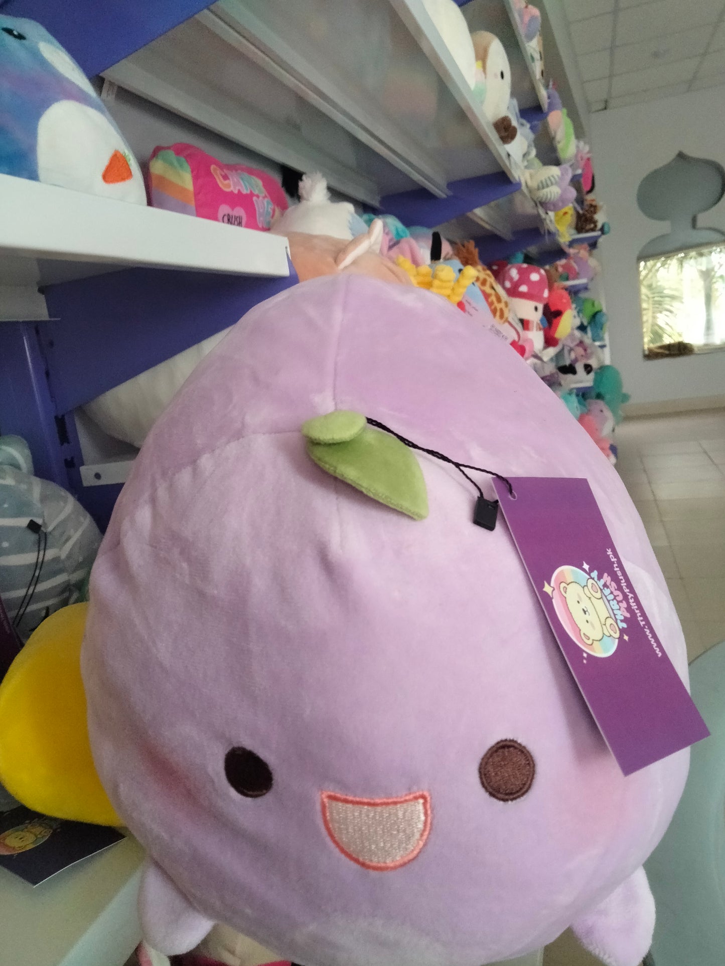 A soft, purple fruit-themed plush toy from Thrifty Plush.