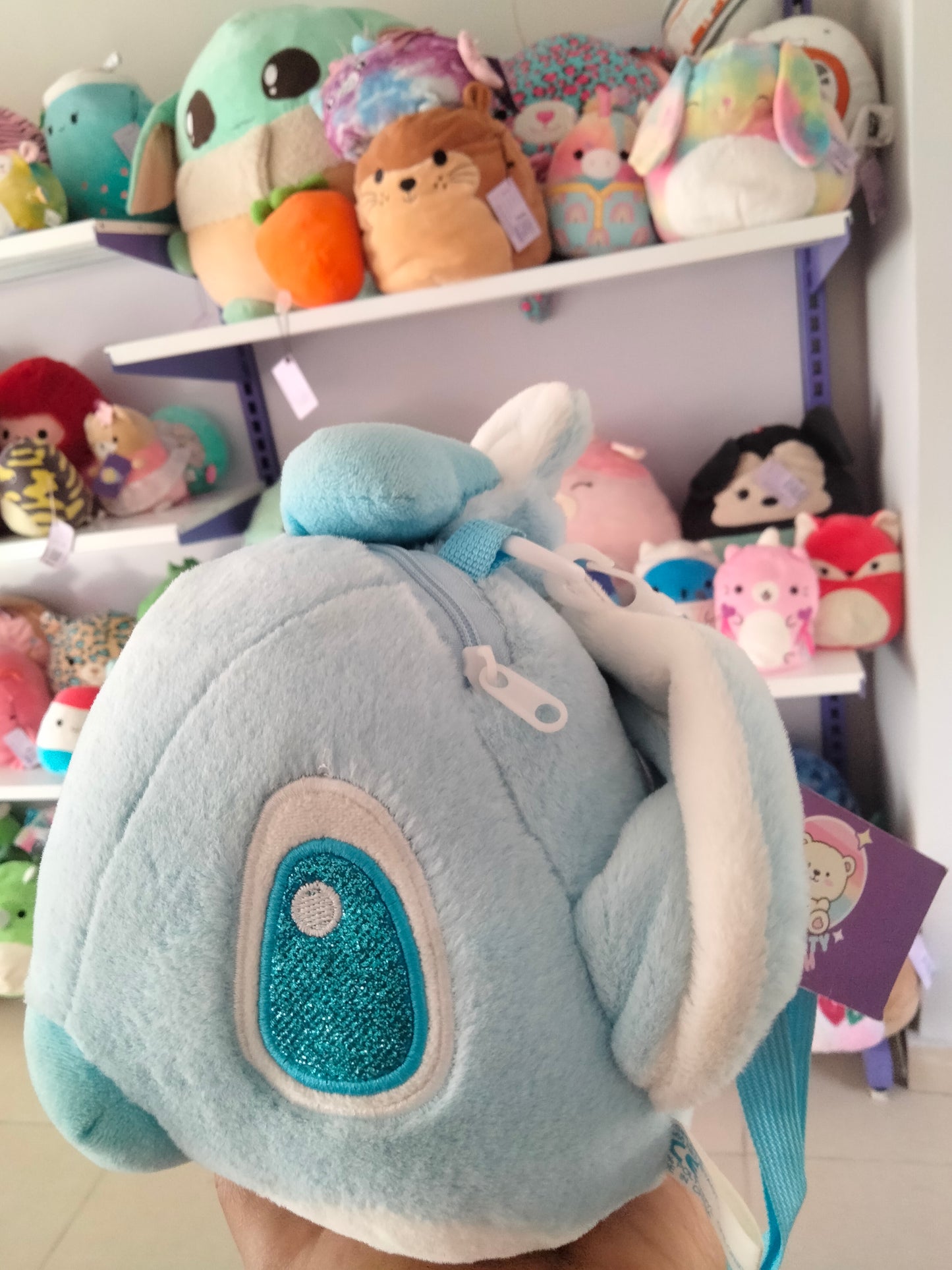 cartoon backpack features a plush toy