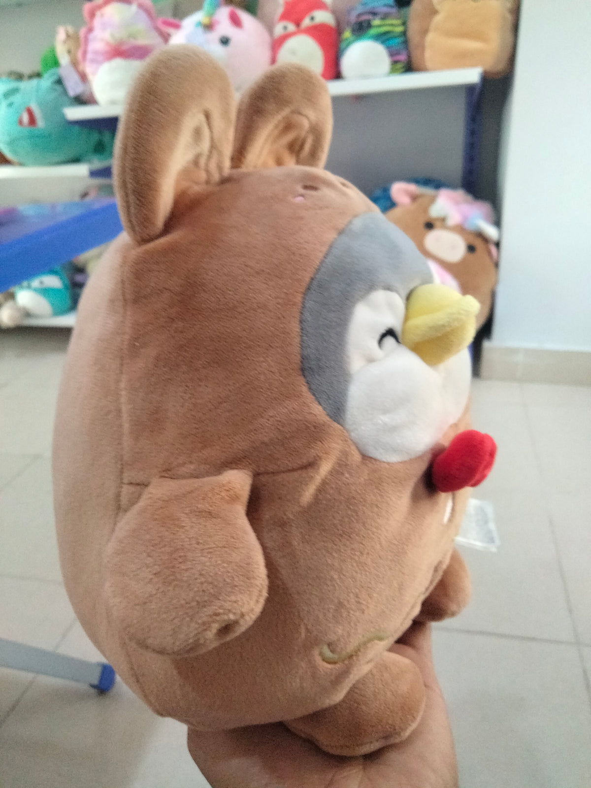 Miniso Mini Family Penguin plush toy wearing a brown rabbit costume.