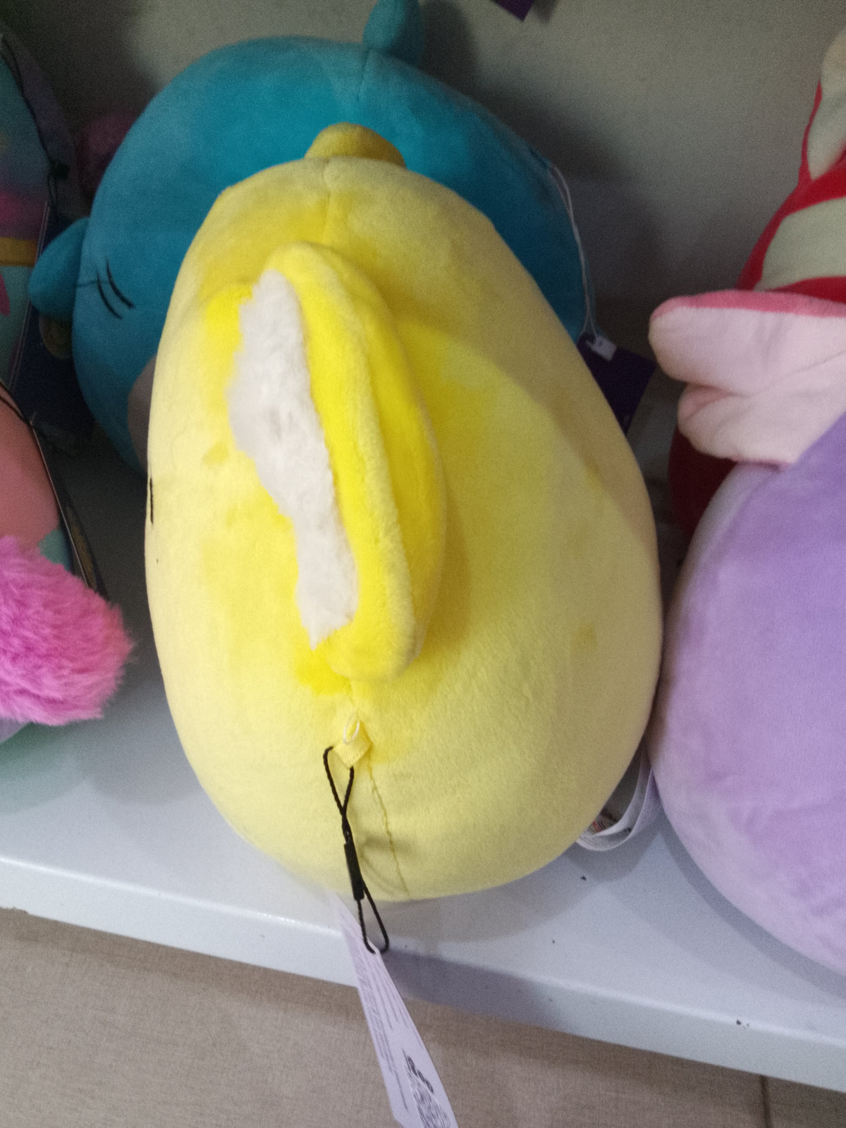 Squishmallows Donny the Koala from the Celebration Squad,yellow plush material and "Happy Birthday" text on the belly.