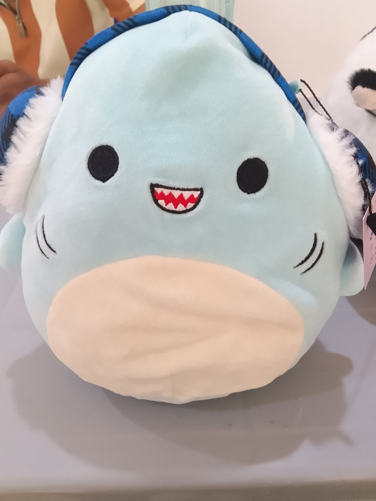 Squishmallows Sharon the Shark Holiday plush featuring festive earmuffs