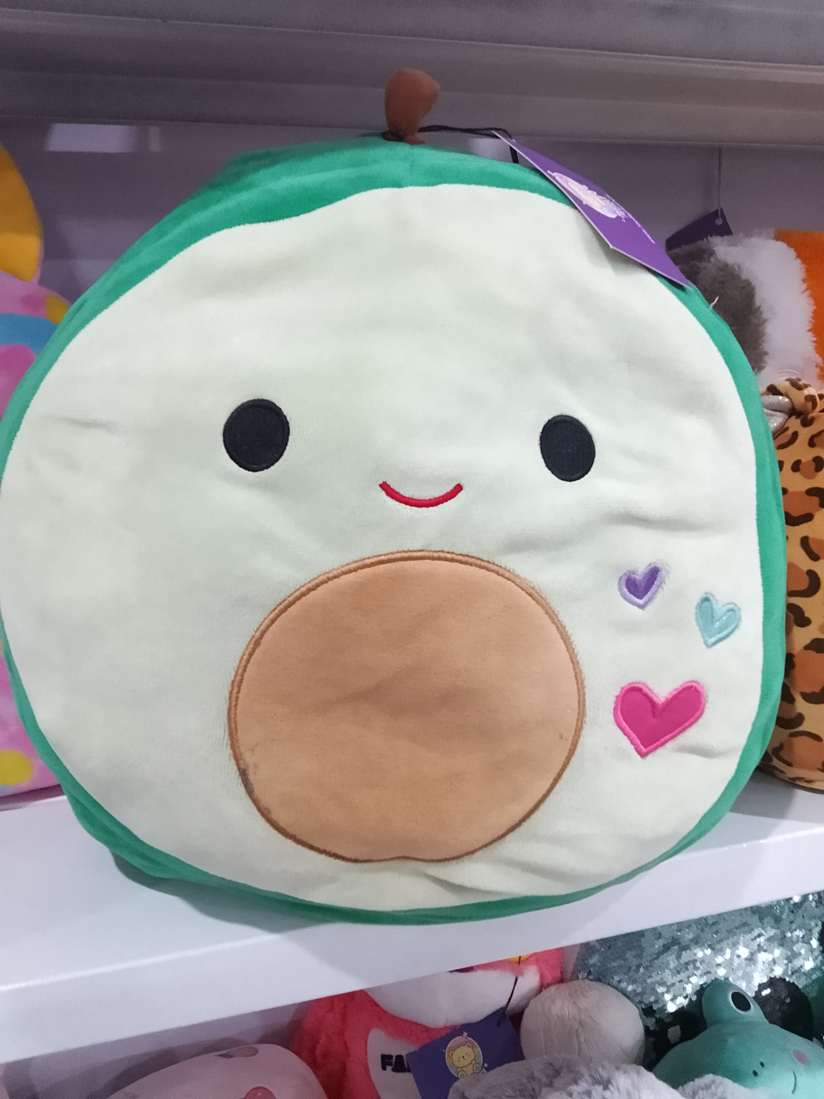 Squishmallows Austin the Avocado plush toy.